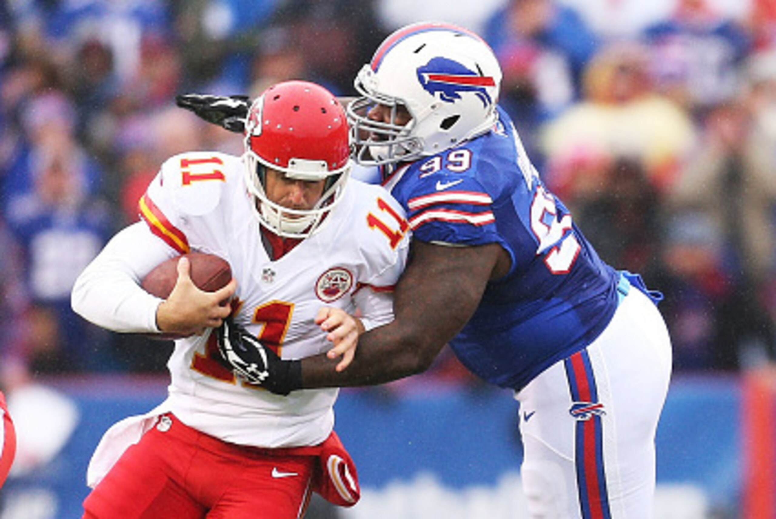 ORCHARD PARK, NY - NOVEMBER 09:   Alex Smith #11 of the Kansas City Chiefs slips past Marcell Dareus #99 of the Buffalo Bills during the first half at Ralph Wilson Stadium on November 9, 2014 in Orchard Park, New York.  (Photo by Brett Carlsen/Getty Image