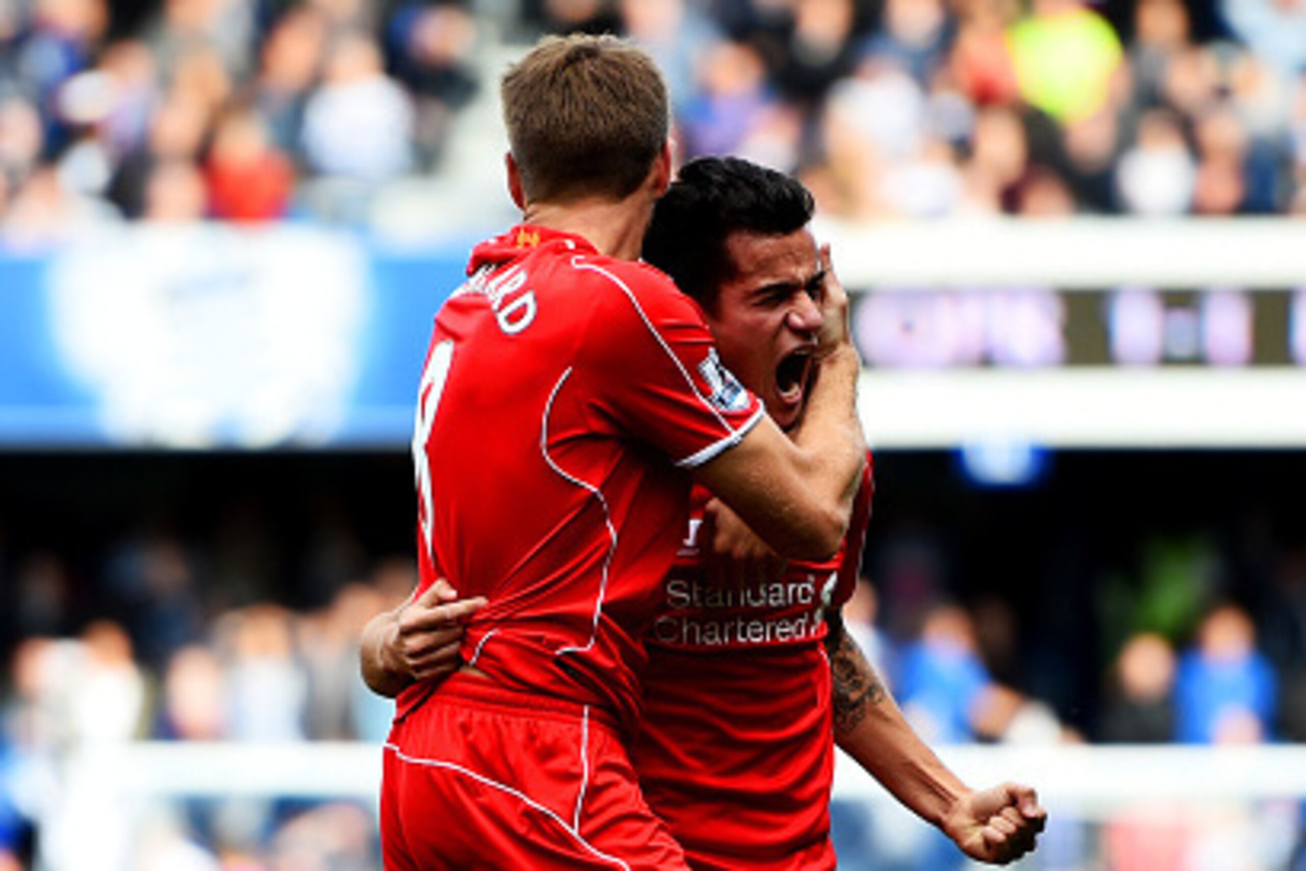 LONDON, ENGLAND - OCTOBER 19:  Philippe Coutinho of Liverpool celebrates with team-mate Steven Gerrard after scoring his team's second goal during the Barclays Premier League match between Queens Park Rangers and Liverpool at Loftus Road on October 19, 20