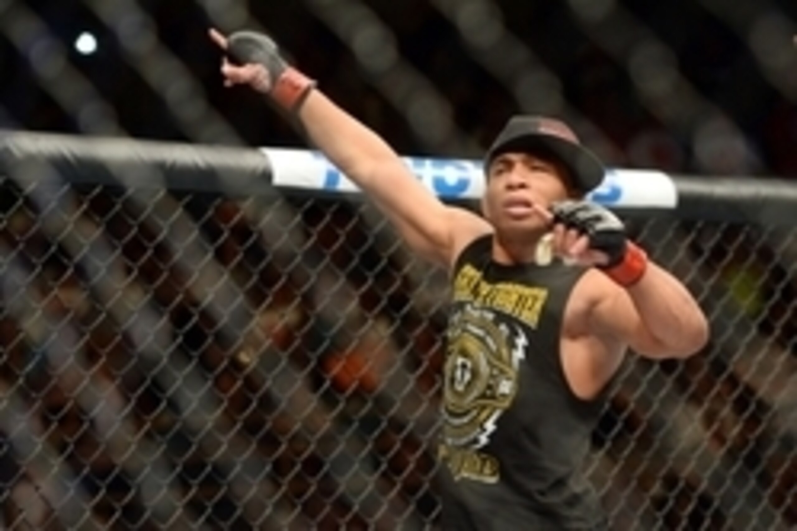 Jun 7, 2014; Albuquerque, NM, USA; John Dodson (red) celebrates his victory over John Moraga (blue) after their flyweight bout during UFC Fight Night 42 at Tingley Coliseum. Dodson won after a doctor's stoppage at the end of round two. Mandatory Credit: J