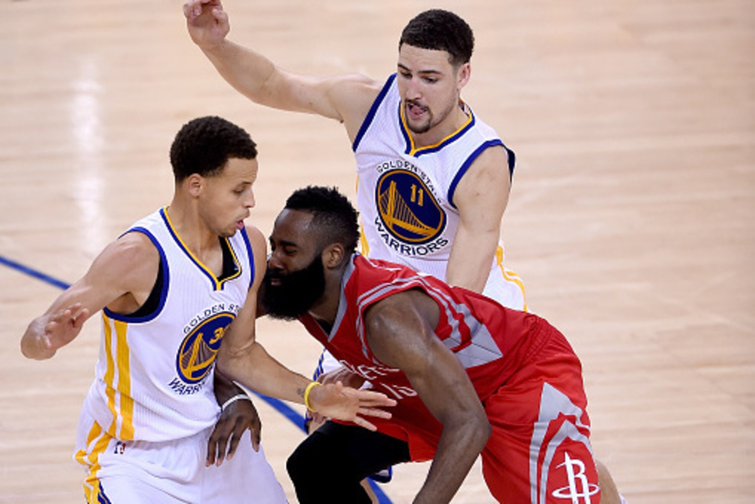 OAKLAND, CA - MAY 21:  Stephen Curry #30 and Klay Thompson #11 of the Golden State Warriors double teams James Harden #13 of the Houston Rockets with seconds left on the clock and the Warriors up 99-98 late in the fourth quarter in Game Two of the Western