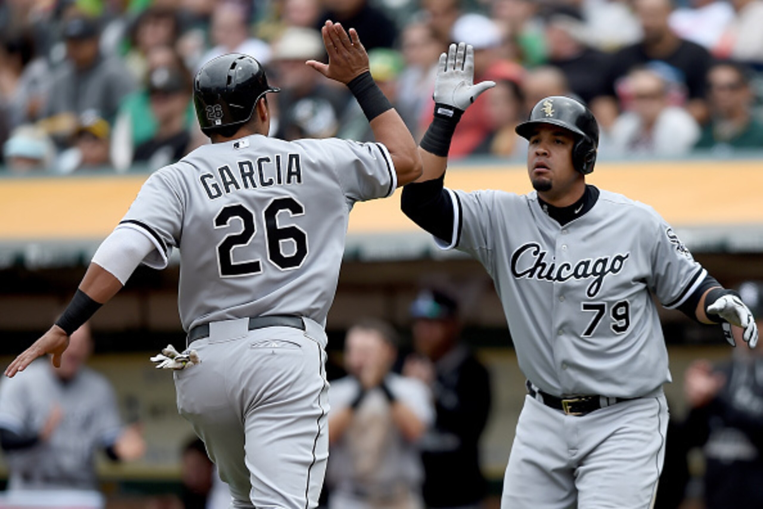 OAKLAND, CA - MAY 17: Avisail Garcia #26 and Jose Abreu #79 of the Chicago White Sox high-five each other after both scored against the Oakland Athletics in the top of the fifth inning at O.co Coliseum on May 17, 2015 in Oakland, California. (Photo by T OAKLAND, CA - MAY 17: Avisail Garcia #26 and Jose Abreu #79 of the Chicago White Sox high-five each other after both scored against the Oakland Athletics in the top of the fifth inning at O.co Coliseum on May 17, 2015 in Oakland, California. (Photo by T