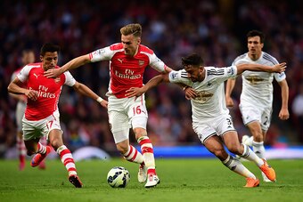 LONDON, ENGLAND - MAY 11: Aaron Ramsey of Arsenal and Neil Taylor of Swansea City battle for the ball during the Barclays Premier League match between Arsenal and Swansea City at Emirates Stadium on May 11, 2015 in London, England.  (Photo by Jamie McDona