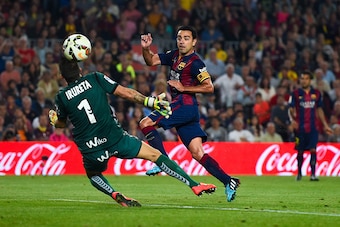 BARCELONA, SPAIN - OCTOBER 18:  Xavi Hernandez of FC Barcelona scores the opening goal past Xabi Irureta of SD Eibar during the La Liga match between FC Barcelona and SD Eibar at Camp Nou on October 18, 2014 in Barcelona, Spain.  (Photo by David Ramos/Get