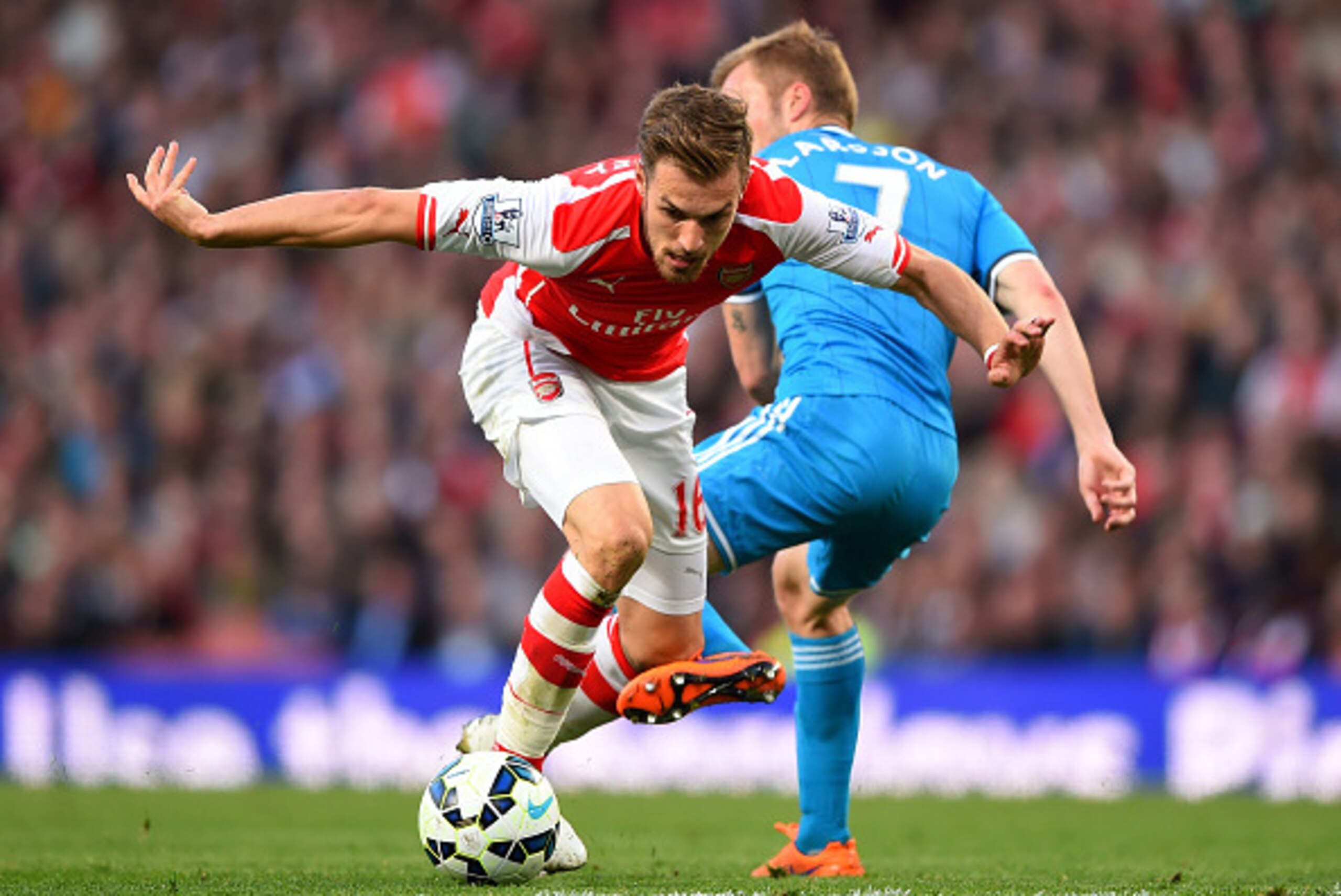 LONDON, ENGLAND - MAY 20:  Aaron Ramsey of Arsenal takes on Sebastian Larsson of Sunderland during the Barclays Premier League match between Arsenal and Sunderland at Emirates Stadium on May 20, 2015 in London, England.  (Photo by Shaun Botterill/Getty Im