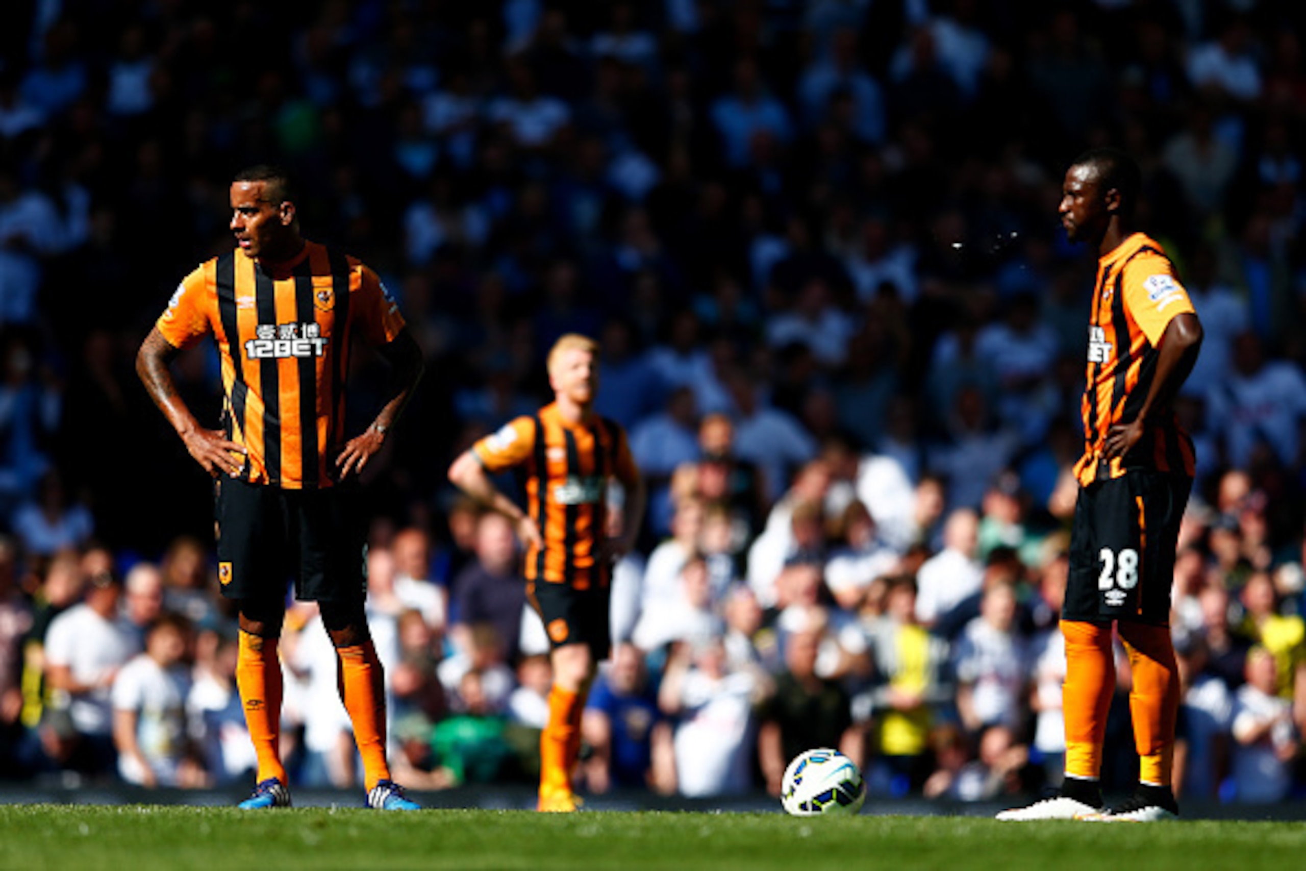 LONDON, ENGLAND - MAY 16:  Tom Huddlestone (L) and Dame N'Doye (R) of Hull City show their dejections after conceding a goal during the Barclays Premier League match between  Tottenham Hotspur and Hull City at White Hart Lane on May 16, 2015 in London, En