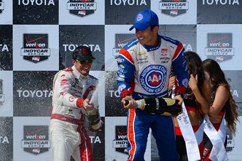 LONG BEACH, CA - APRIL 19: Helio Castroneves of Brazil (right) and Scott Dixon of New Zealand driver of the #9 Target Chip Ganassi Racing Chevrolet Dallara respectively celebrate coming in second and first place during the Verizon IndyCar Series Toyota Gr
