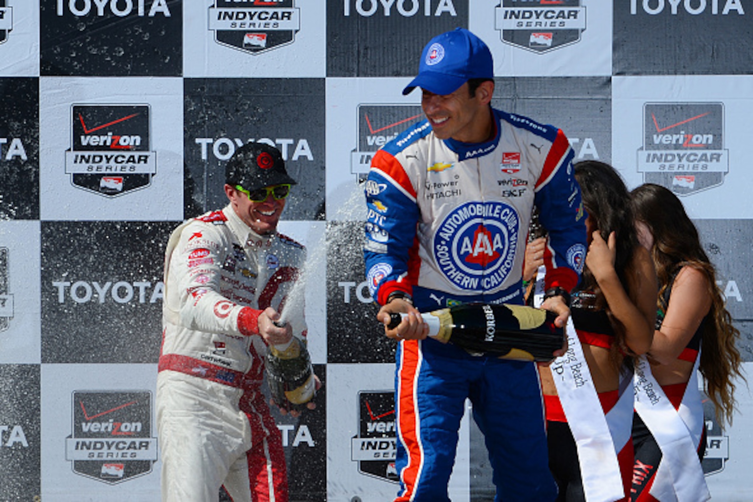 LONG BEACH, CA - APRIL 19: Helio Castroneves of Brazil (right) and Scott Dixon of New Zealand driver of the #9 Target Chip Ganassi Racing Chevrolet Dallara respectively celebrate coming in second and first place during the Verizon IndyCar Series Toyota Gr