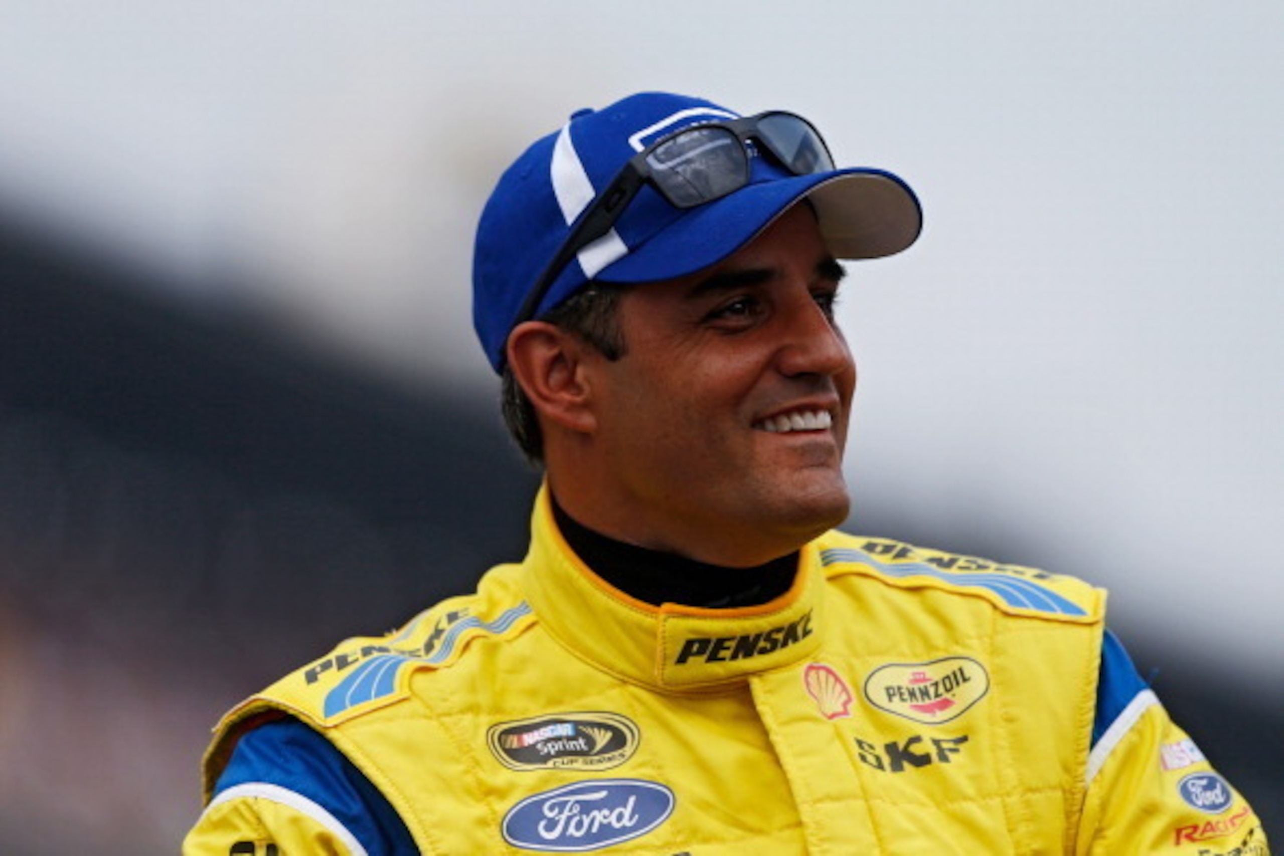 INDIANAPOLIS, IN - JULY 27:  Juan Pablo Montoya, driver of the #12 Penske Truck Rental Ford, participates in pre-race ceremonies for the NASCAR Sprint Cup Series Crown Royal Presents The John Wayne Walding 400 at the Brickyard Indianapolis Motor Speedway 