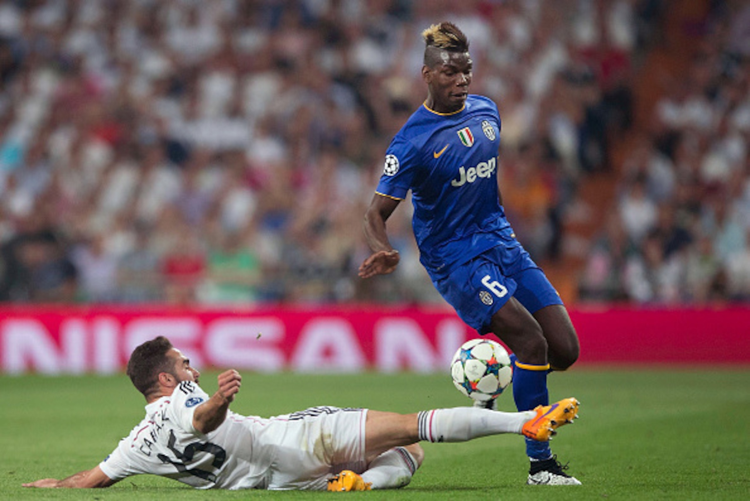 MADRID, SPAIN - MAY 13: Paul Pogba of Juventus is tackled by Daniel Carvajal of Real Madrid during the UEFA Champions League Semi Final, second leg match between Real Madrid and Juventus at Estadio Santiago Bernabeu on May 13, 2015 in Madrid, Spain. (P MADRID, SPAIN - MAY 13: Paul Pogba of Juventus is tackled by Daniel Carvajal of Real Madrid during the UEFA Champions League Semi Final, second leg match between Real Madrid and Juventus at Estadio Santiago Bernabeu on May 13, 2015 in Madrid, Spain. (P