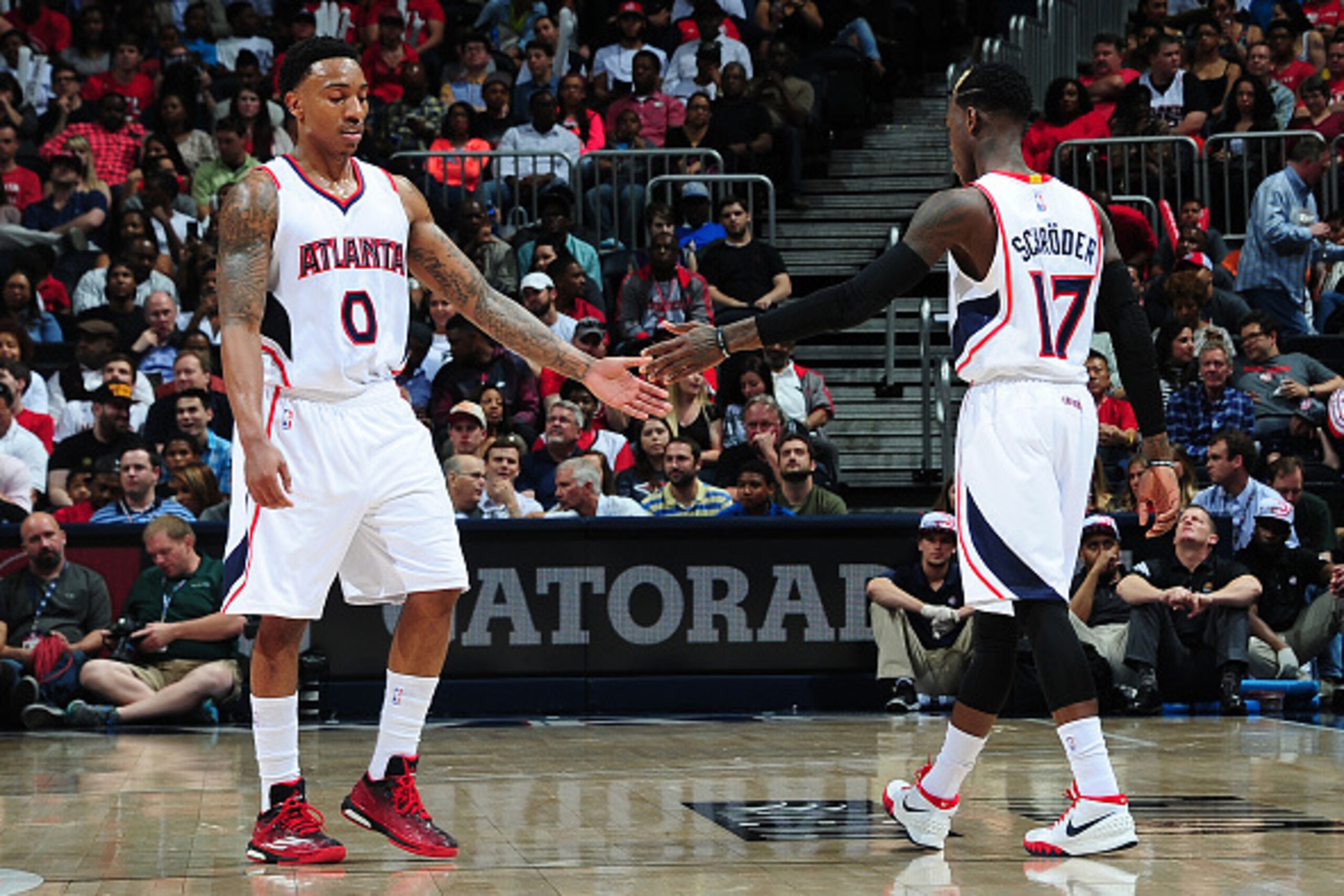 ATLANTA, GA - APRIL 7:  Jeff Teague #0 and Dennis Schroder #17 of the Atlanta Hawks shake hands during the game against the Phoenix Suns on April 7, 2015 at Philips Arena in Atlanta, Georgia.  NOTE TO USER: User expressly acknowledges and agrees that, by 