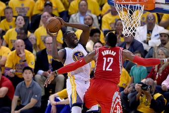 OAKLAND, CA - MAY 21:  Draymond Green #23 of the Golden State Warriors shoots and is fouled by Dwight Howard #12 of the Houston Rockets during the second half in Game Two of the Western Conference Finals of the NBA Playoffs at ORACLE Arena on May 21, 2015