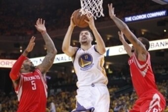 May 21, 2015; Oakland, CA, USA; Golden State Warriors guard Klay Thompson (11) moves to the basket against the defense of Houston Rockets forward Josh Smith (5) and forward Trevor Ariza (1) during the second half in game two of the Western Conference Fina