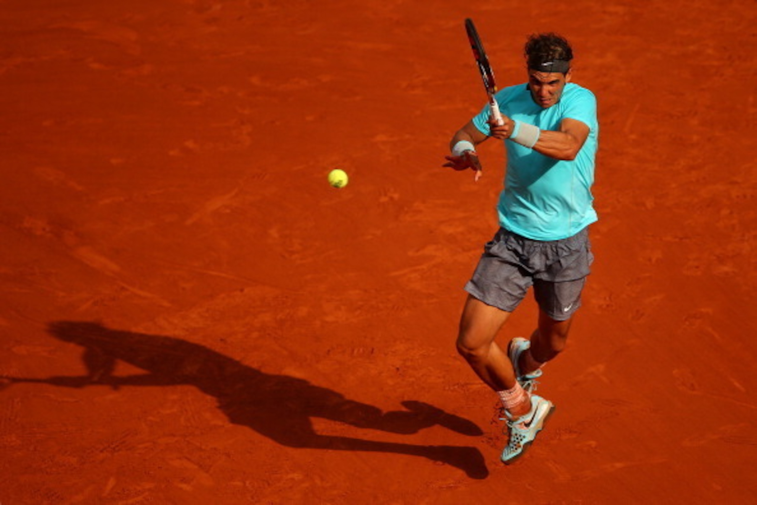 PARIS, FRANCE - JUNE 08:  Rafael Nadal of Spain returns a shot during his men's singles final match against Novak Djokovic of Serbia on day fifteen of the French Open at Roland Garros on June 8, 2014 in Paris, France.  (Photo by Clive Brunskill/Getty Imag