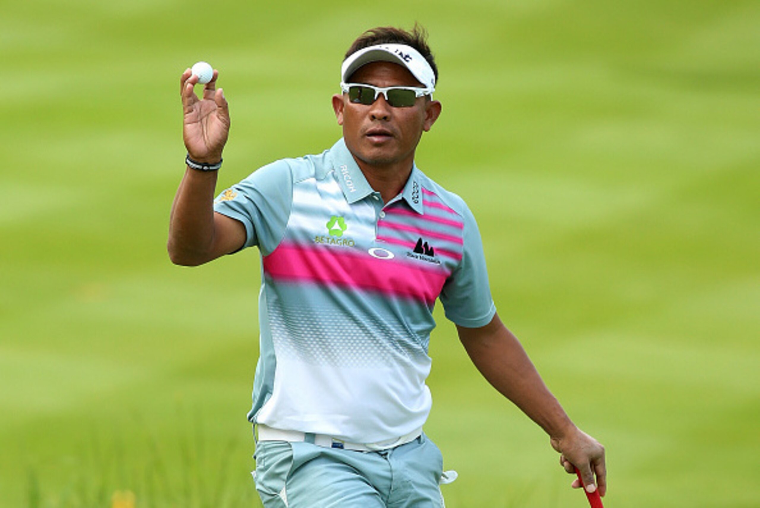 VIRGINIA WATER, ENGLAND - MAY 22:  Thongchai Jaidee of Thailand acknowledges the crowd on the 18th green during day 2 of the BMW PGA Championship at Wentworth on May 22, 2015 in Virginia Water, England.  (Photo by Andrew Redington/Getty Images)