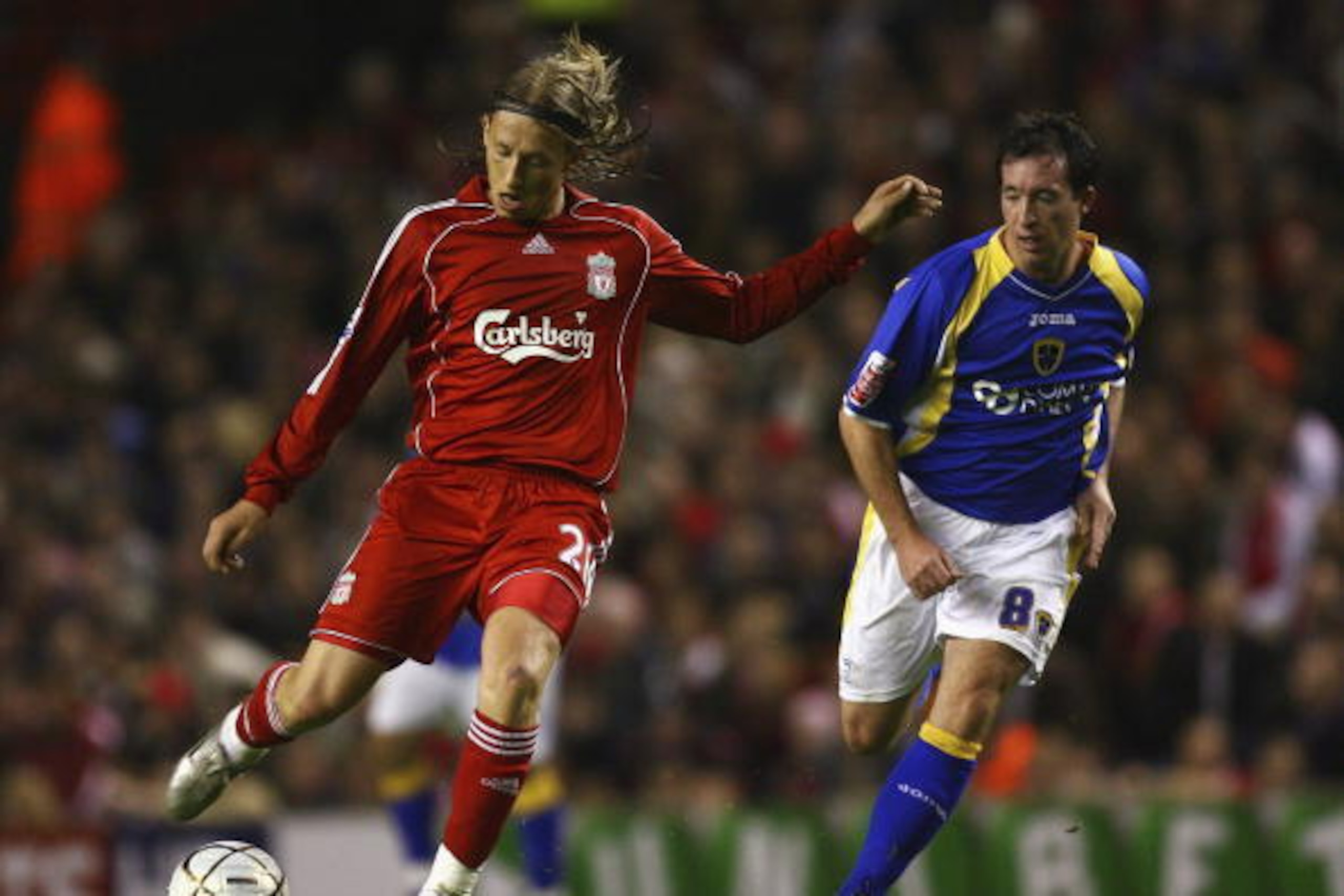 LIVERPOOL, UNITED KINGDOM - OCTOBER 31:  Leiva Lucas of Liverpool passes the ball under pressure from Robbie Fowler of Cardiff City during the Carling Cup fourth round match between Liverpool and Cardiff City at Anfield on October 31, 2007 in Liverpool, E