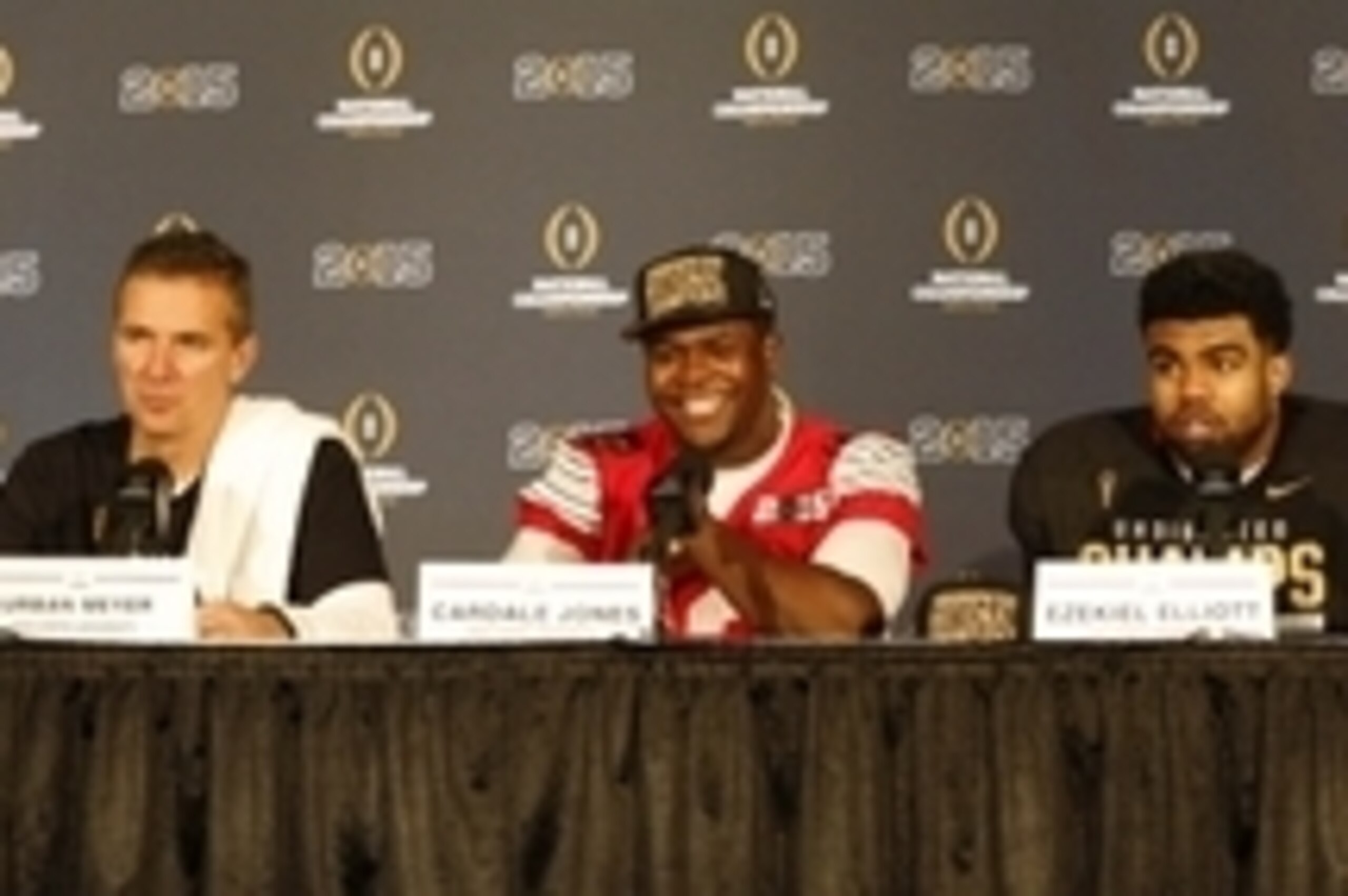 Jan 12, 2015; Arlington, TX, USA; Ohio State Buckeyes head coach Urban Meyer, quarterback Cardale Jones (12) and running back Ezekiel Elliott (15) during a press conference after beating the Oregon Ducks in the 2015 CFP National Championship Game at AT&T Jan 12, 2015; Arlington, TX, USA; Ohio State Buckeyes head coach Urban Meyer, quarterback Cardale Jones (12) and running back Ezekiel Elliott (15) during a press conference after beating the Oregon Ducks in the 2015 CFP National Championship Game at AT&T