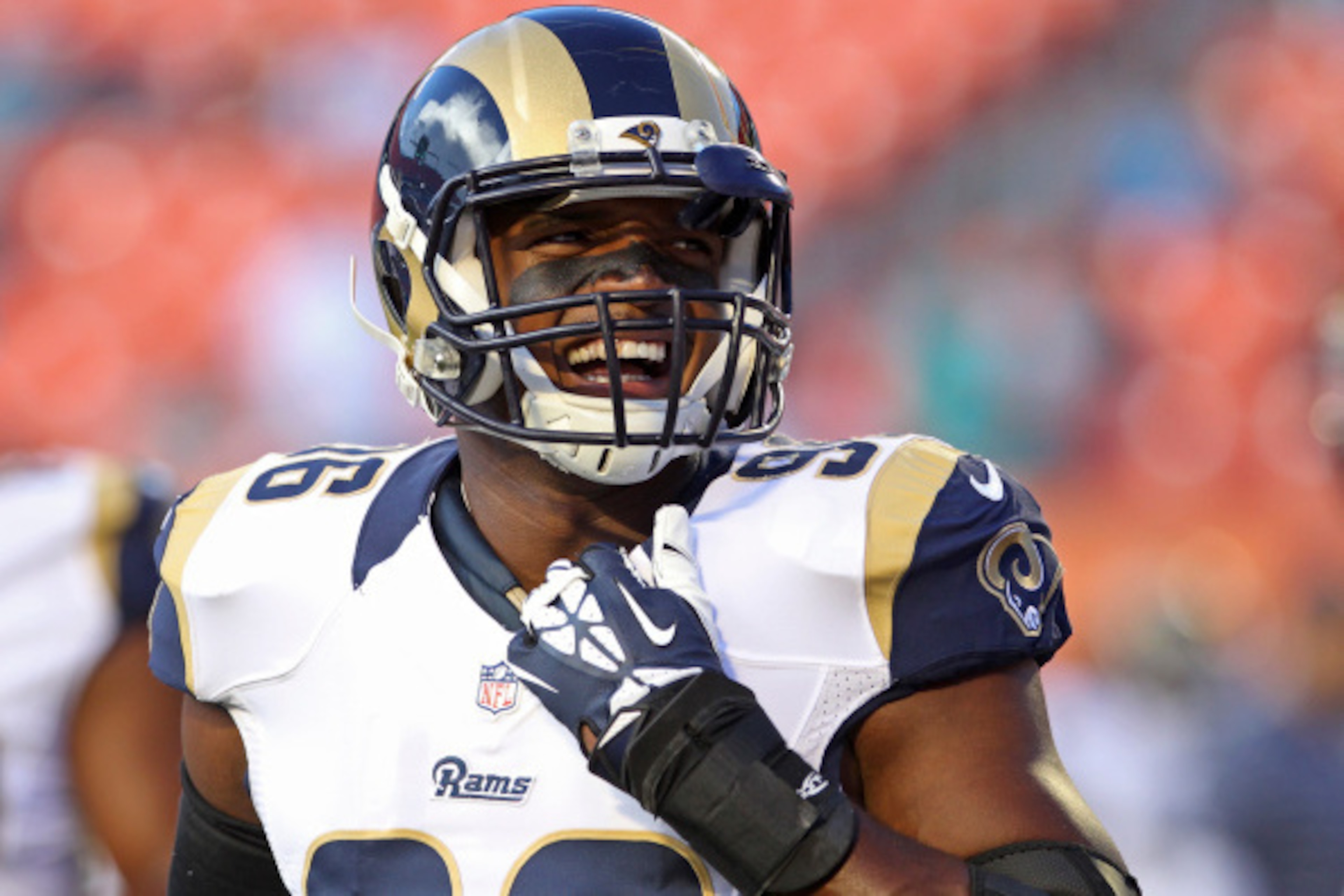 MIAMI GARDENS, FL - AUGUST 28:  Defensive end Michael Sam #96 of the St. Louis Rams reacts during pregame workouts before his team met the Miami Dolphins at Sun Life Stadium on August 28, 2014 in Miami Gardens, Florida.  (Photo by Marc Serota/Getty Images