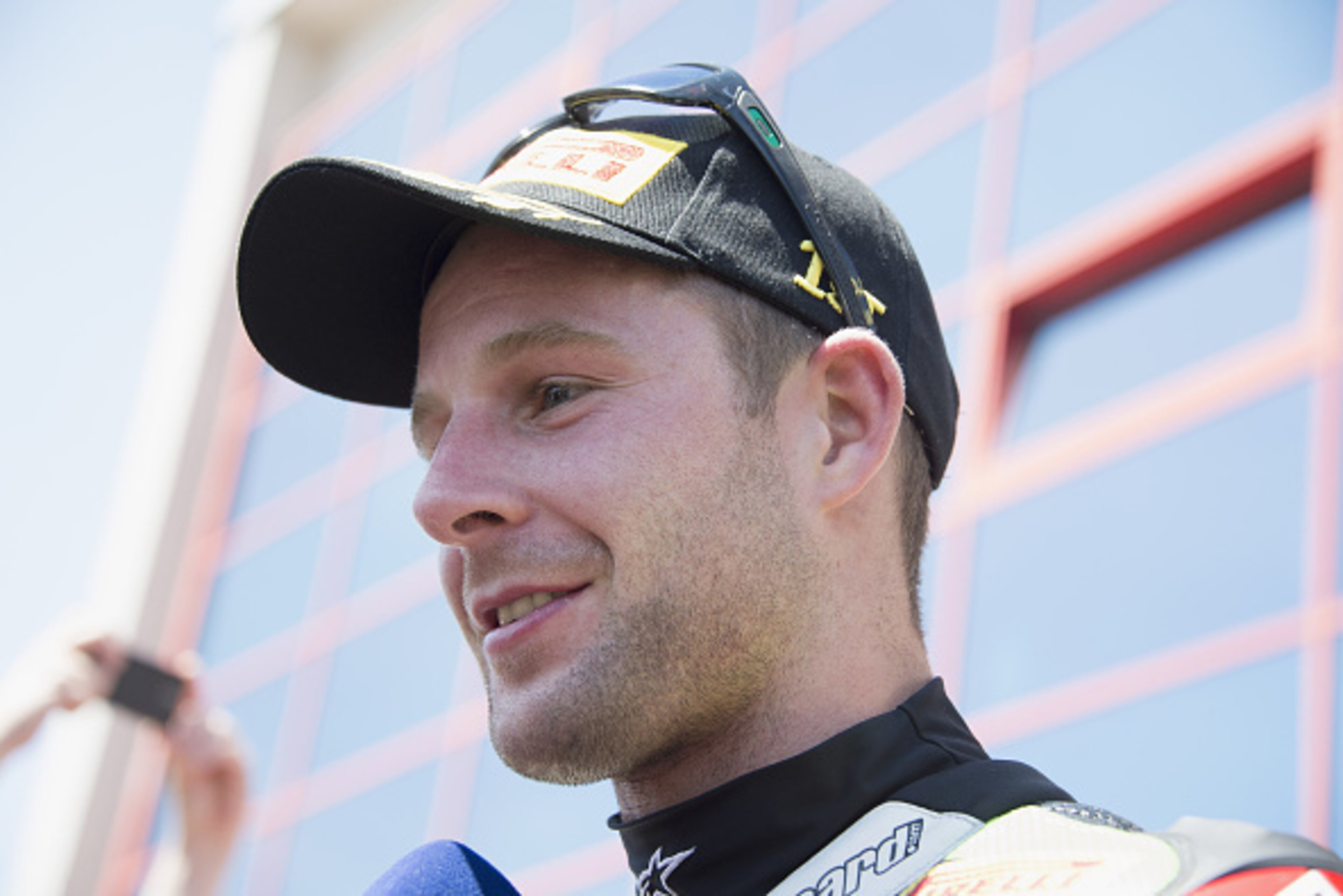 IMOLA, ITALY - MAY 10:  Jonathan Rea of Great Britain and KAWASAKI RACING TEAM  speaks with journalists and celebrates the victory under the podium at the end of the WSBK race 2 during the World Superbikes - Race at Enzo & Dino Ferrari Circuit on May 10, 