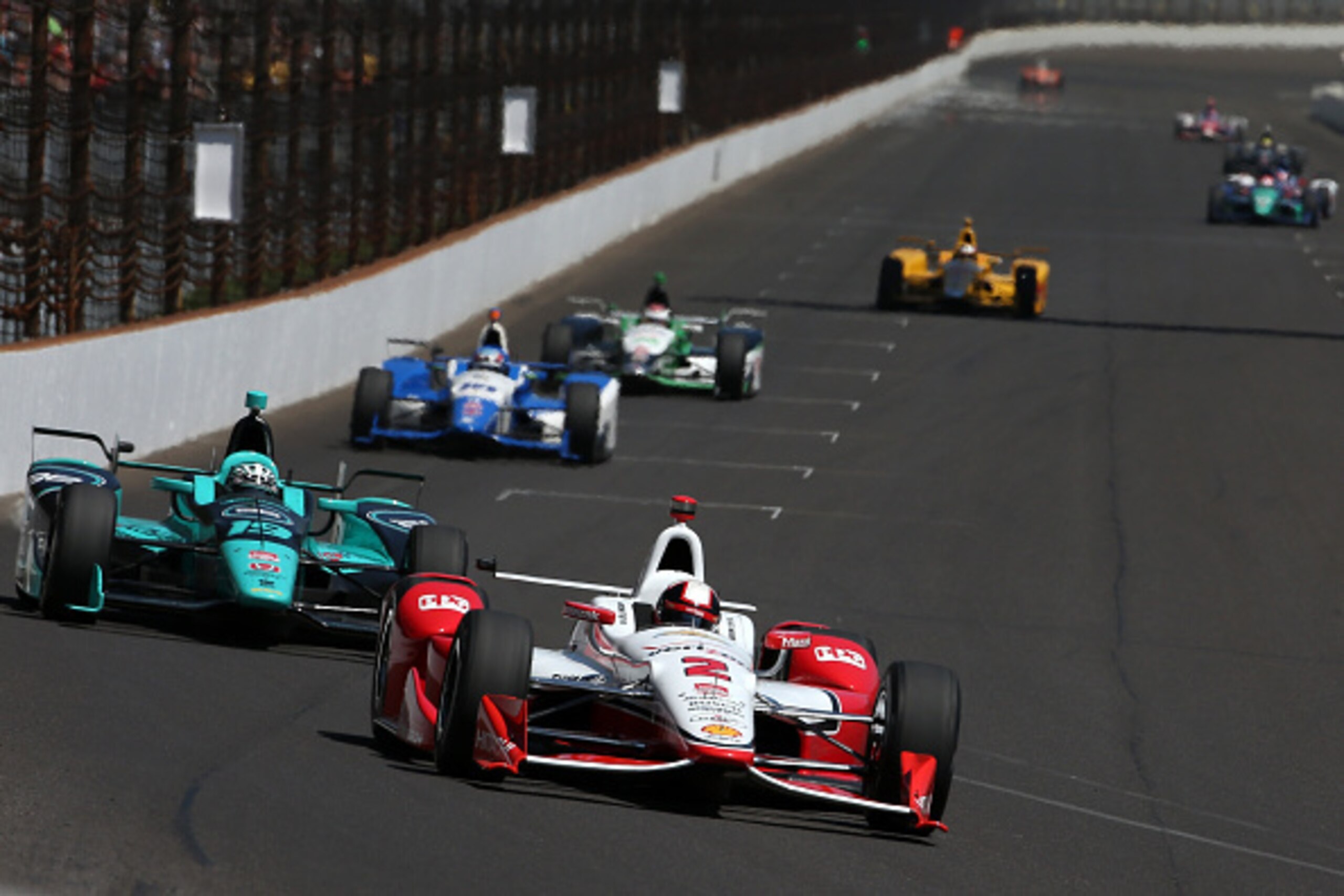 INDIANAPOLIS, IN - MAY 22:  Juan Pablo Montoya of Colombia driver of the #2 Team Penske Chevrolet Dallara  leads a pack of cars during final practice on Carb Day for the the 99th running of the Indianapolis 500 Mile Race at Indianapolis Motorspeedway on M