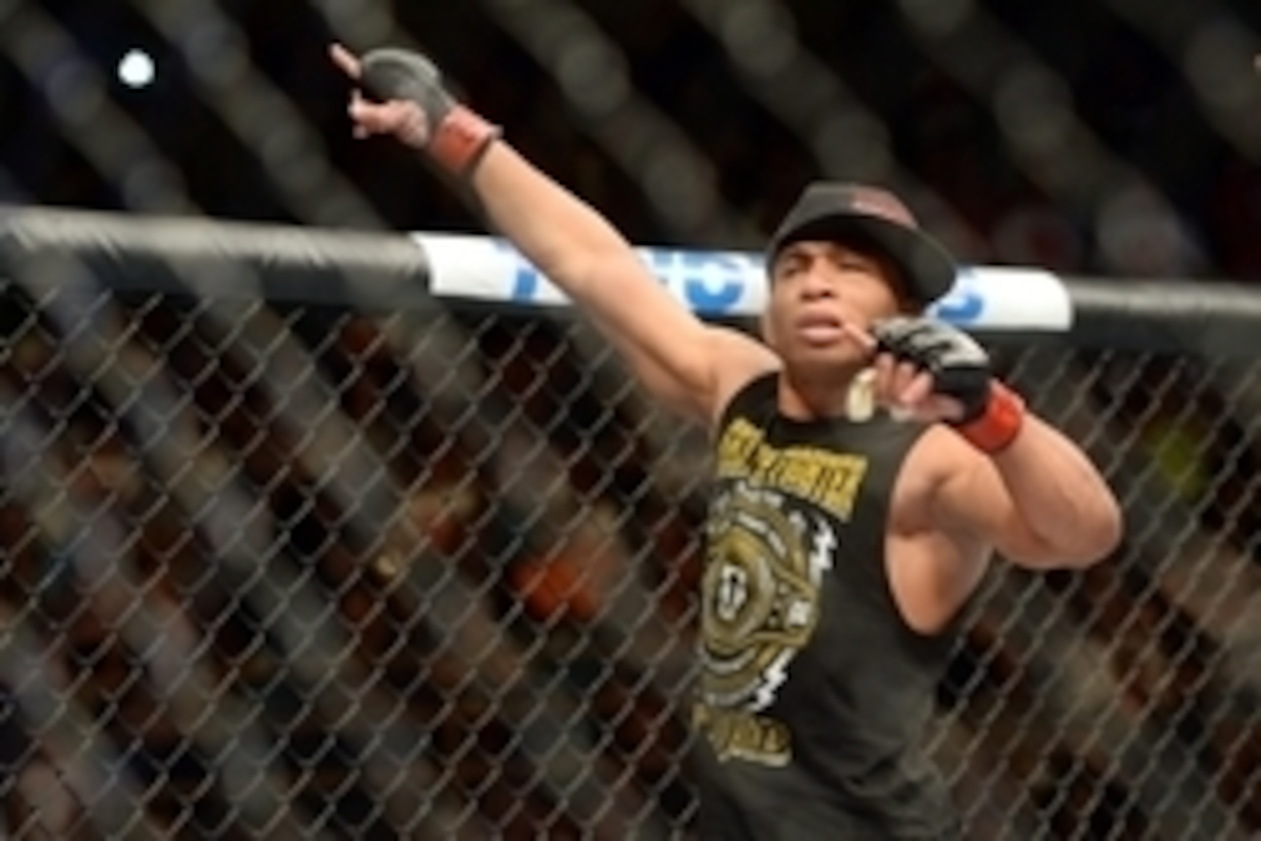 Jun 7, 2014; Albuquerque, NM, USA; John Dodson (red) celebrates his victory over John Moraga (blue) after their flyweight bout during UFC Fight Night 42 at Tingley Coliseum. Dodson won after a doctor's stoppage at the end of round two. Mandatory Credit: J