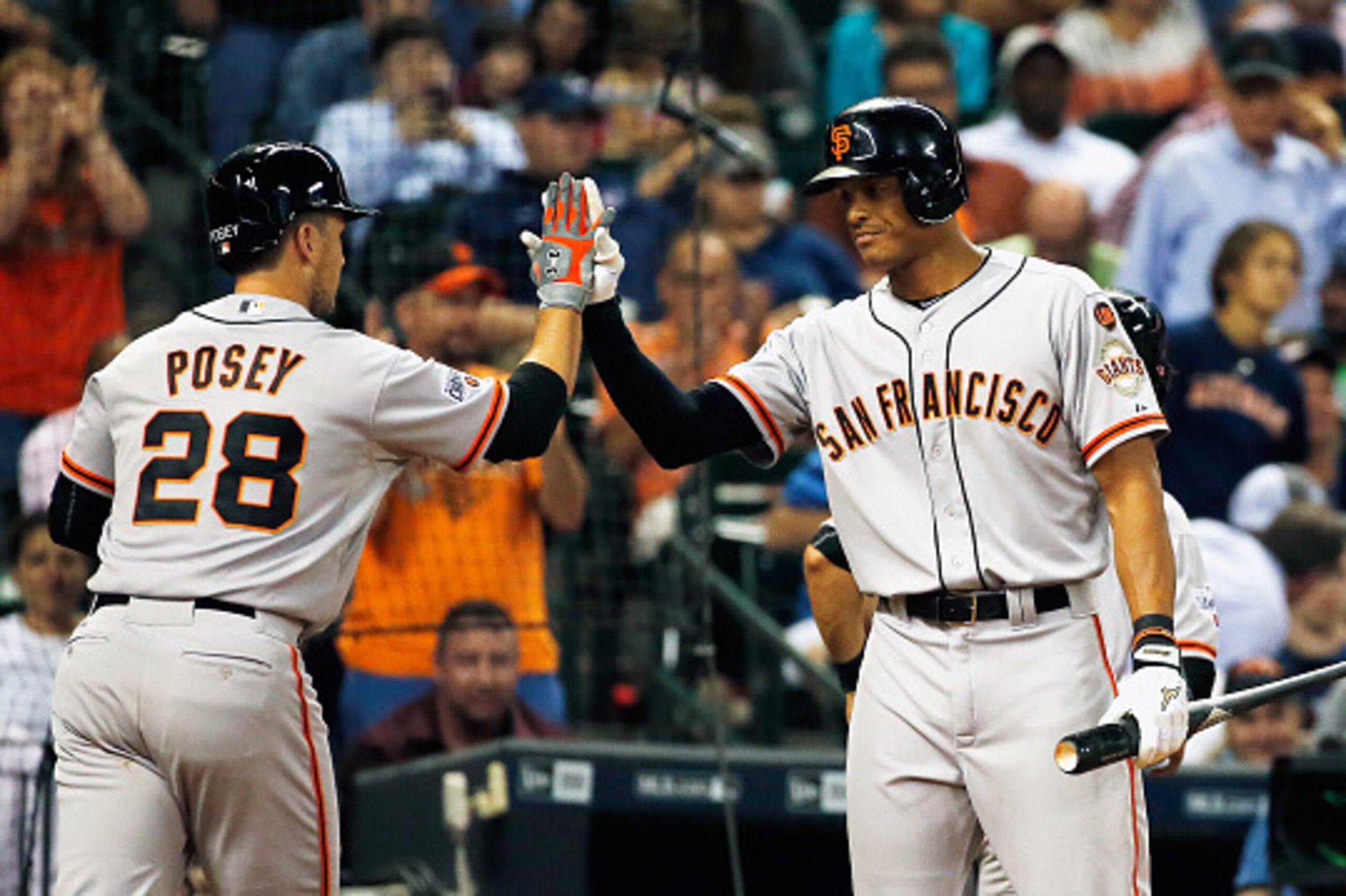 HOUSTON, TX - MAY 13:  Justin Maxwell #43 of the San Francisco Giants (R) greets his teammate Buster Posey #28 after Posey hit a two-run home run in the fifth inning of their game against the Houston Astros at Minute Maid Park on May 13, 2015 in Houston, 