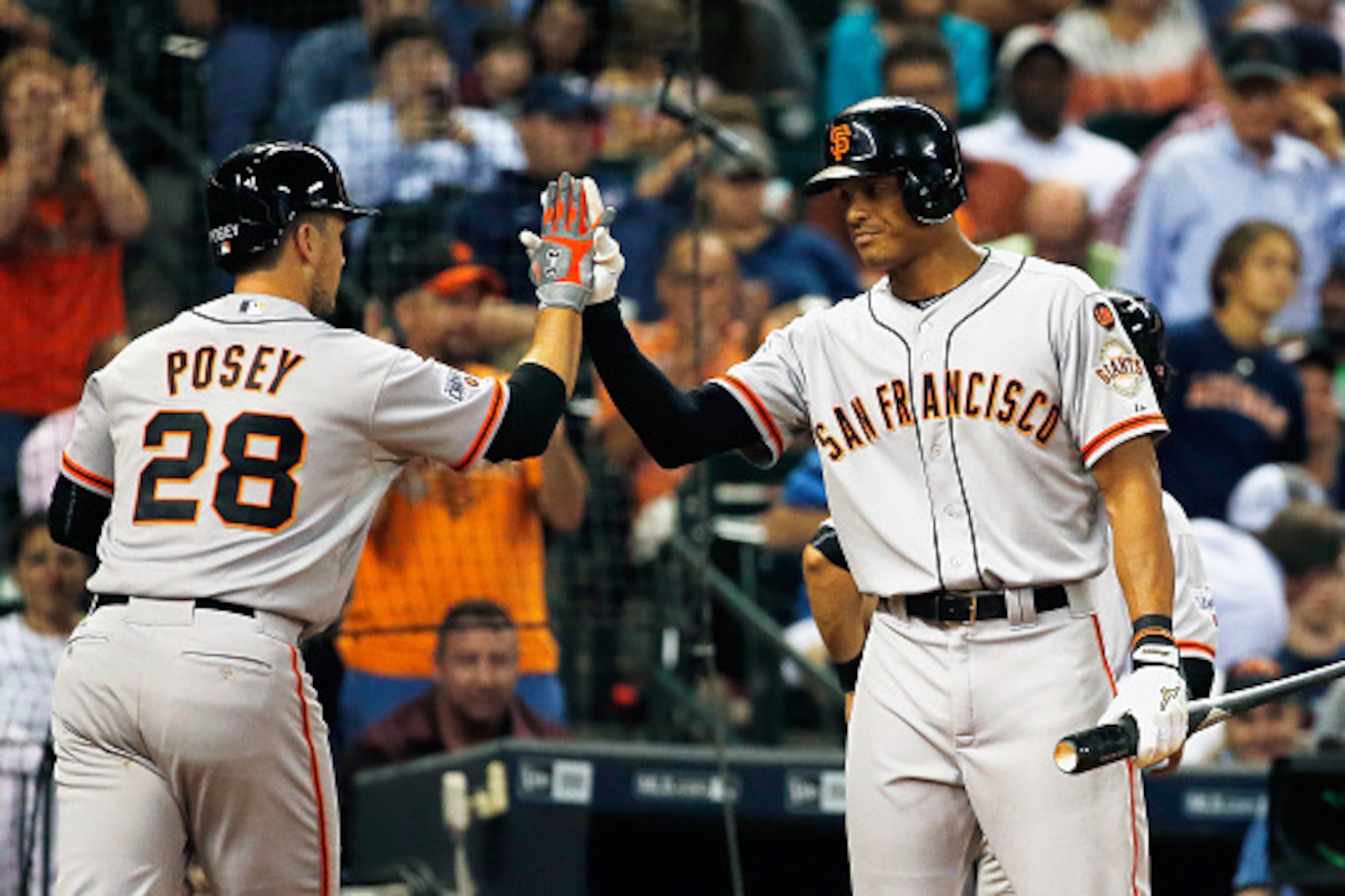 HOUSTON, TX - MAY 13:  Justin Maxwell #43 of the San Francisco Giants (R) greets his teammate Buster Posey #28 after Posey hit a two-run home run in the fifth inning of their game against the Houston Astros at Minute Maid Park on May 13, 2015 in Houston, 
