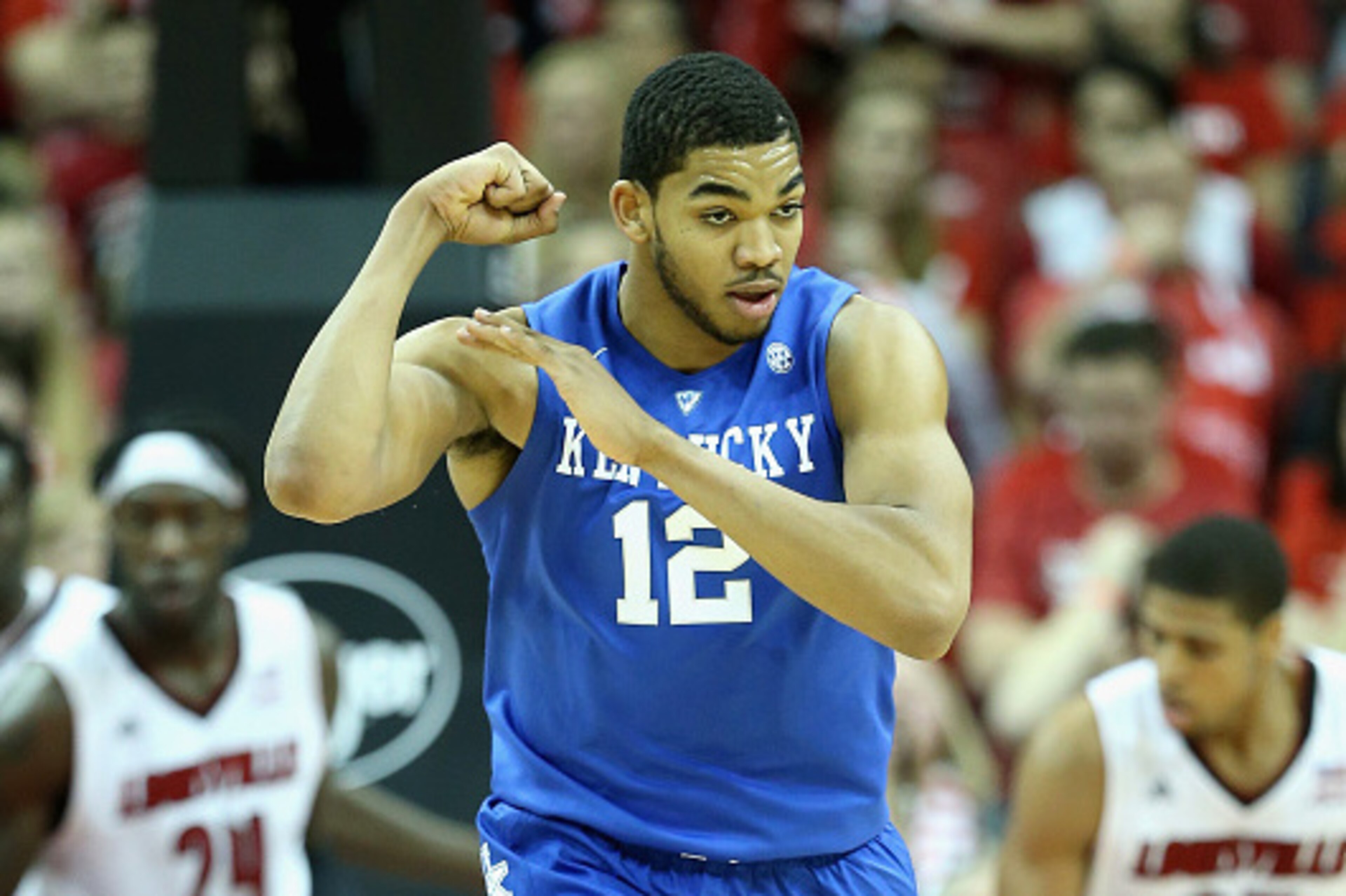 LOUISVILLE, KY - DECEMBER 27:  Karl-Anthony Towns #12  of the Kentucky Wildcats celebrates by flexing his muscles during the game against the Louisville Cardinals at KFC YUM! Center on December 27, 2014 in Louisville, Kentucky.  Kentucky won 58-50.  (Phot