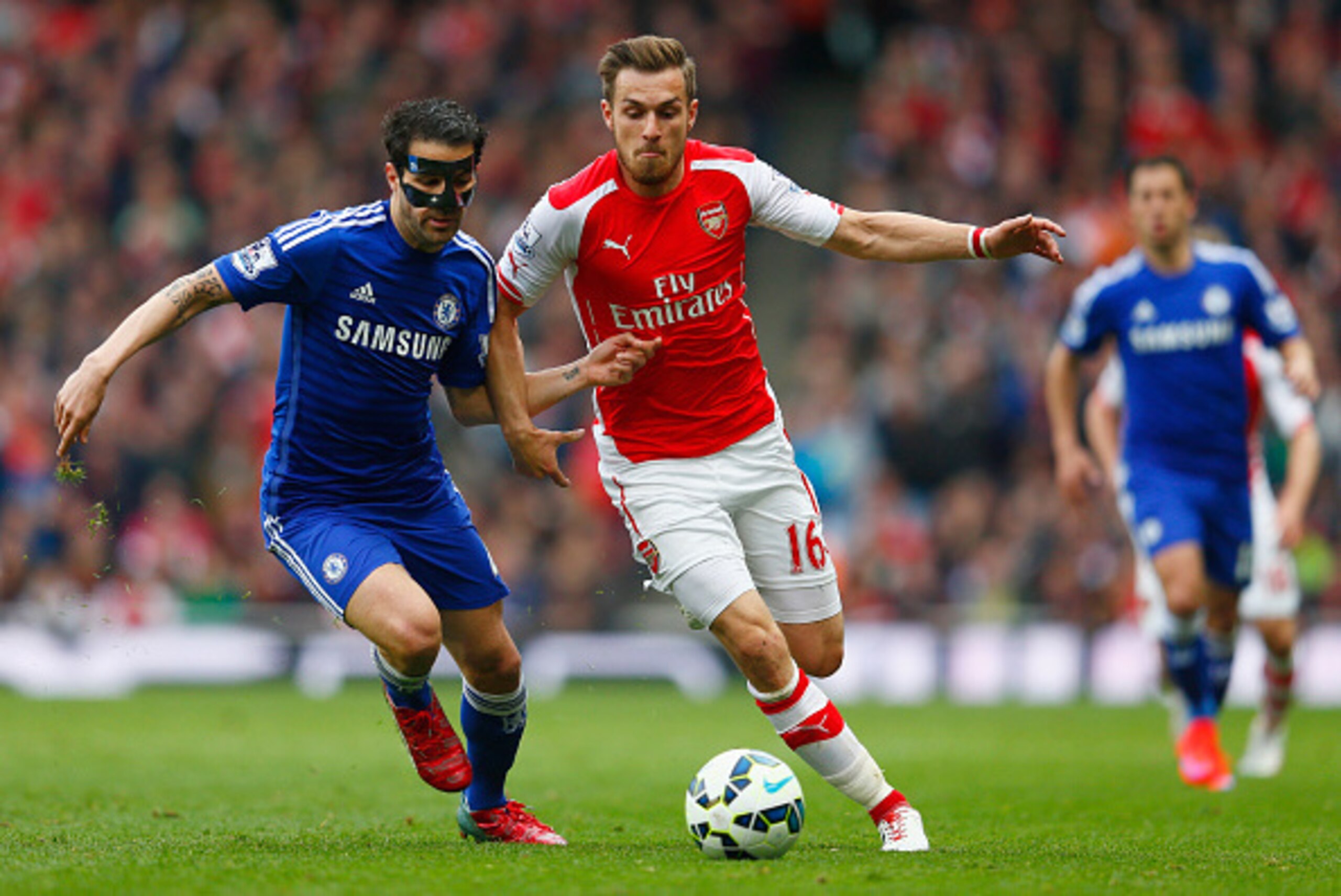 LONDON, ENGLAND - APRIL 26: Cesc Fabregas of Chelsea and Aaron Ramsey of Arsenal battle for the ball during the Barclays Premier League match between Arsenal and Chelsea at Emirates Stadium on April 26, 2015 in London, England. (Photo by Julian Finney/G LONDON, ENGLAND - APRIL 26: Cesc Fabregas of Chelsea and Aaron Ramsey of Arsenal battle for the ball during the Barclays Premier League match between Arsenal and Chelsea at Emirates Stadium on April 26, 2015 in London, England. (Photo by Julian Finney/G