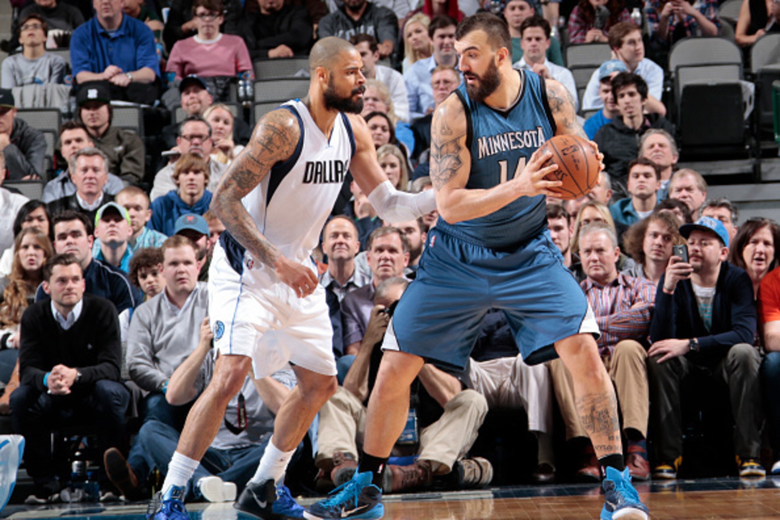 DALLAS, TX - FEBRUARY 2: Nikola Pekovic #14 of the Minnesota Timberwolves handles the ball against Tyson Chandler #6 of the Dallas Mavericks on February 2, 2015 at the American Airlines Center in Dallas, Texas. NOTE TO USER: User expressly acknowledges an