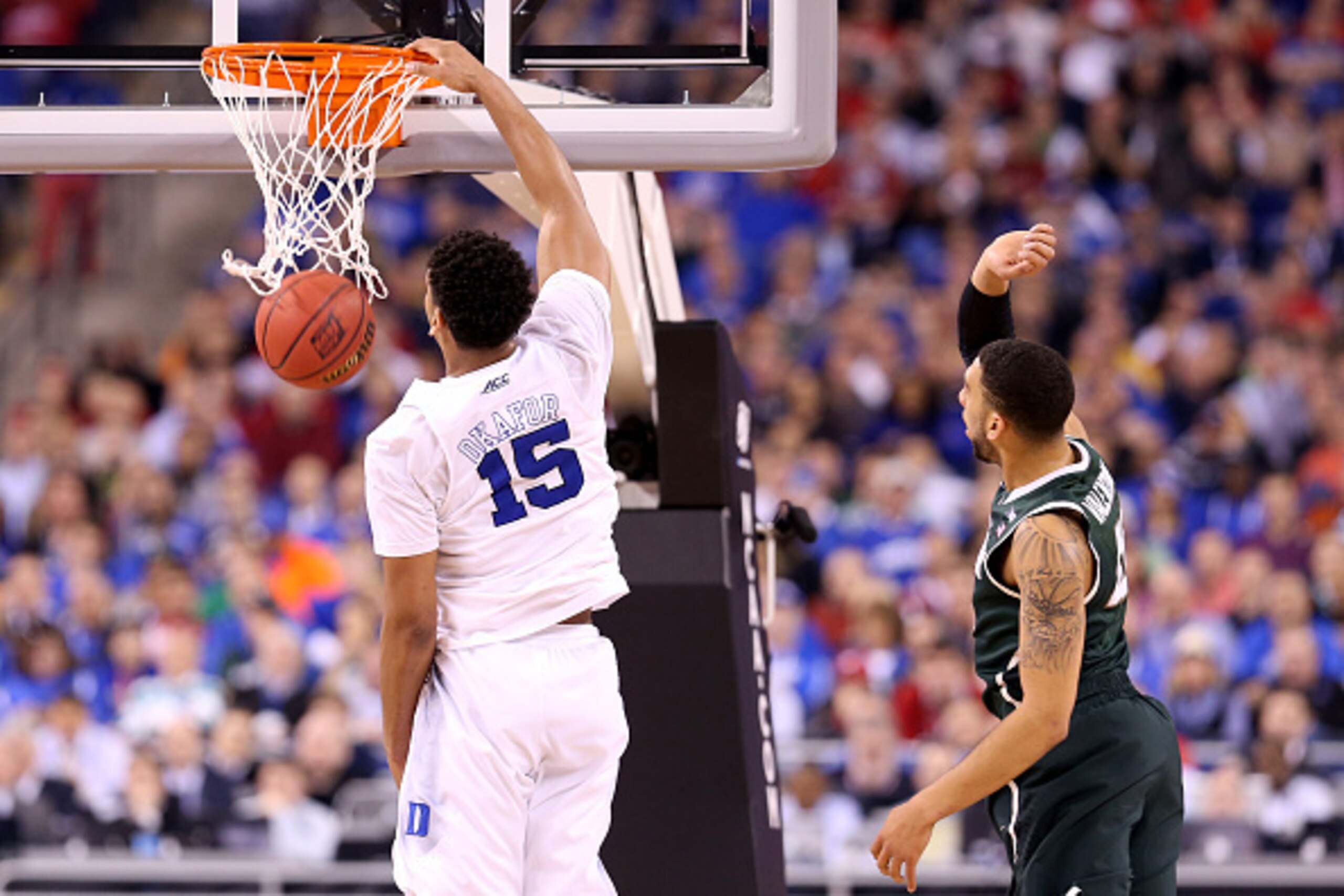 INDIANAPOLIS, IN - APRIL 04:  Jahlil Okafor #15 of the Duke Blue Devils dunks the ball against Denzel Valentine #45 of the Michigan State Spartans during the NCAA Men's Final Four Semifinal at Lucas Oil Stadium on April 4, 2015 in Indianapolis, Indiana.  