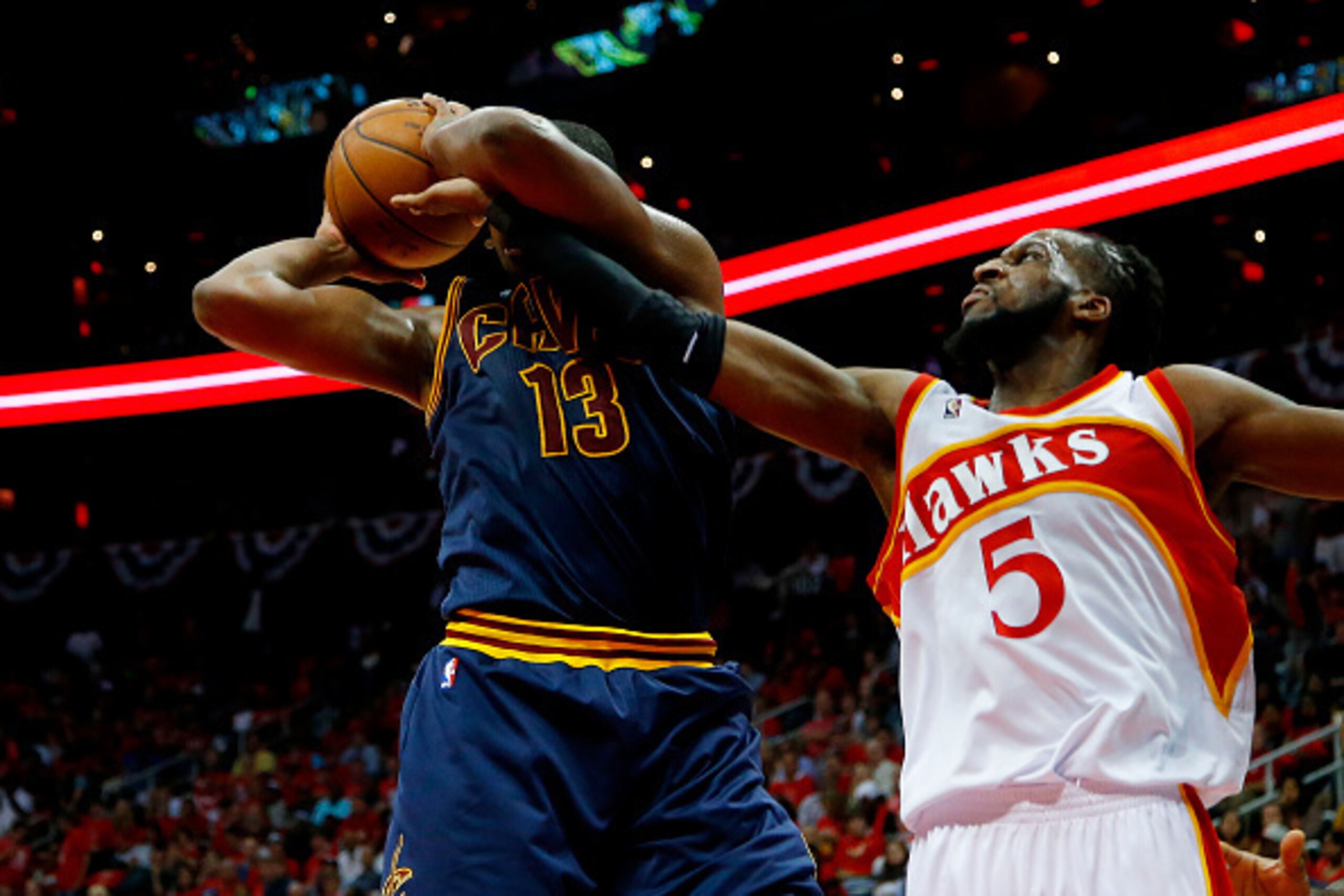 ATLANTA, GA - MAY 22:  Tristan Thompson #13 of the Cleveland Cavaliers rebounds against DeMarre Carroll #5 of the Atlanta Hawks in the third quarter during Game Two of the Eastern Conference Finals of the 2015 NBA Playoffs at Philips Arena on May 22, 2015