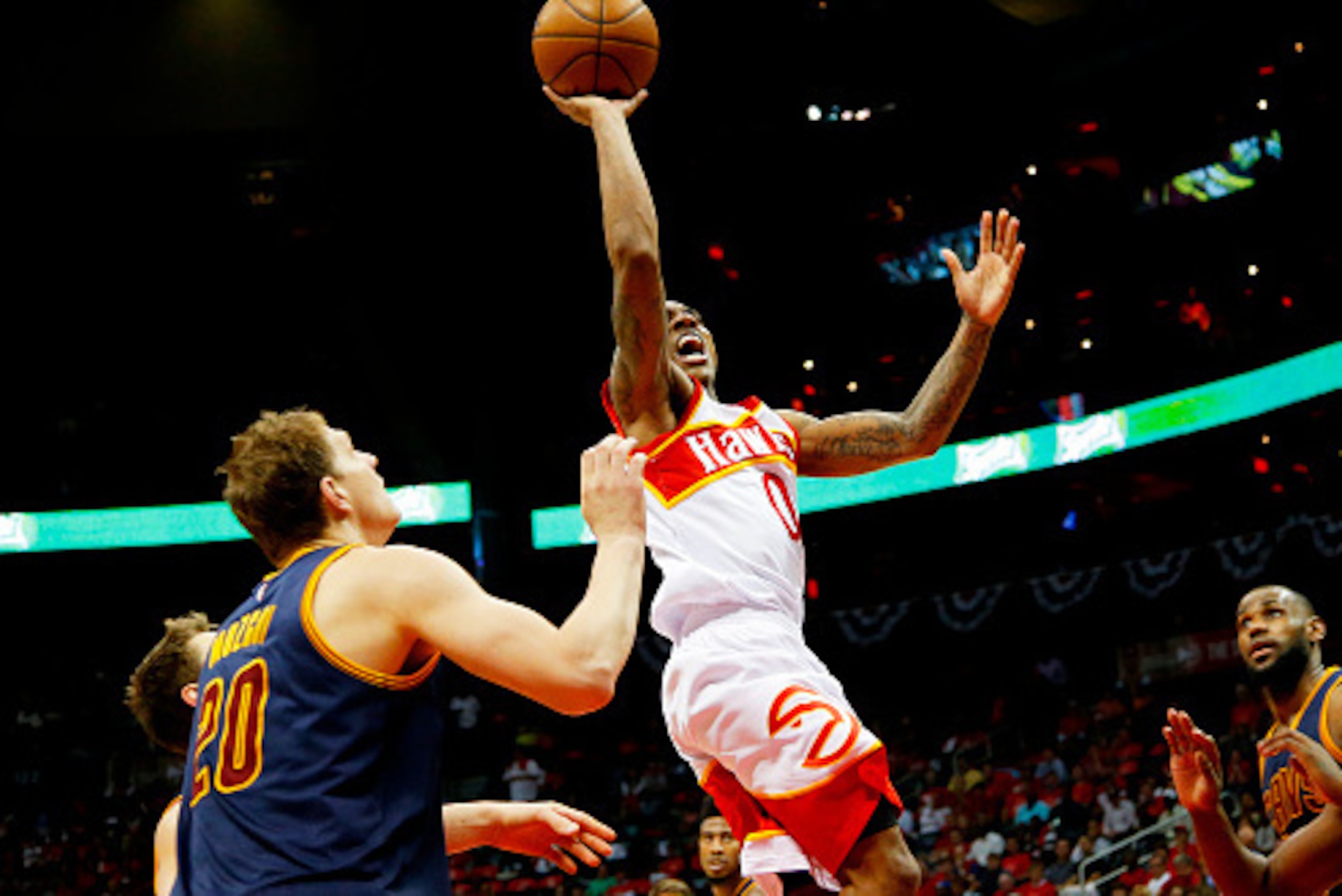 ATLANTA, GA - MAY 22:  Jeff Teague #0 of the Atlanta Hawks goes up against Timofey Mozgov #20 of the Cleveland Cavaliers in the third quarter during Game Two of the Eastern Conference Finals of the 2015 NBA Playoffs at Philips Arena on May 22, 2015 in Atl