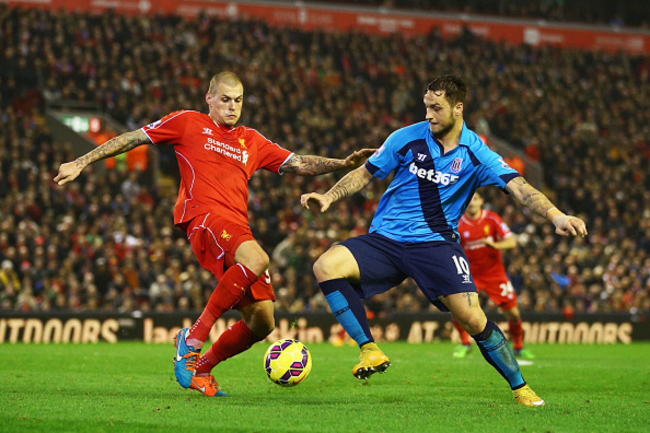 LIVERPOOL, ENGLAND - NOVEMBER 29:  Martin Skrtel of Liverpool tackles Marko Arnautovic of Stoke City during the Barclays Premier League match between Liverpool and Stoke City at Anfield on November 29, 2014 in Liverpool, England.  (Photo by Richard Heathc