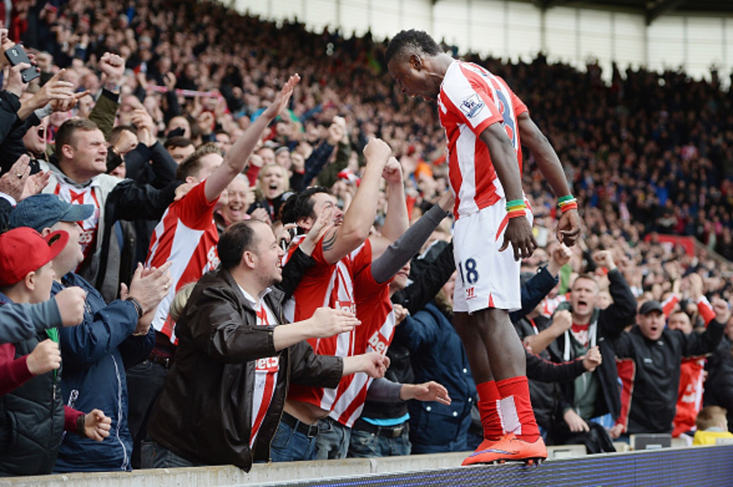 STOKE ON TRENT, ENGLAND - MAY 09:  Mame Biram Diouf of Stoke City celebrates his team's third goal with fans during the Barclays Premier League match between Stoke City and Tottenham Hotspur at Britannia Stadium on May 9, 2015 in Stoke on Trent, England. 