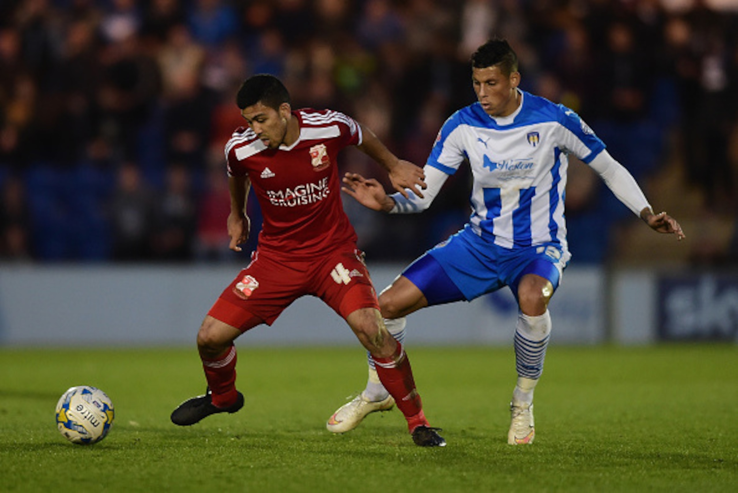 COLCHESTER, ENGLAND - APRIL 28:  Gavin Massey of Colchester United battles with Massimo Luongo of Swindon Town during the Sky Bet League One match between Colchester United and Swindon Town at Colchester Community Stadium on April 28, 2015 in Colchester, 