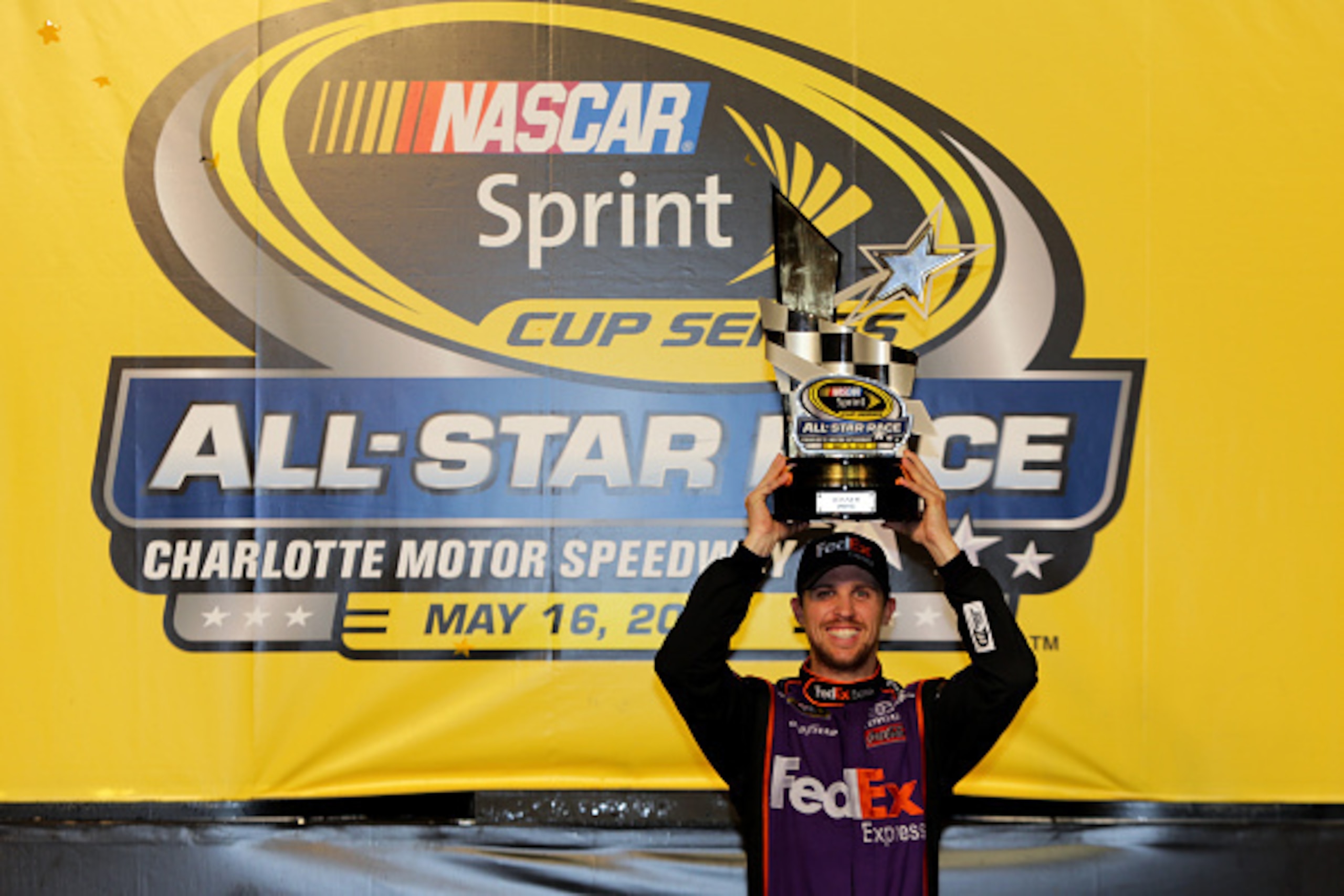 CHARLOTTE, NC - MAY 16: Denny Hamlin, driver of the #11 FedEx Express Toyota, poses in victory lane after winning the NASCAR Sprint Cup Series Sprint All-Star Race at Charlotte Motor Speedway on May 16, 2015 in Charlotte, North Carolina. (Photo by Jerry CHARLOTTE, NC - MAY 16: Denny Hamlin, driver of the #11 FedEx Express Toyota, poses in victory lane after winning the NASCAR Sprint Cup Series Sprint All-Star Race at Charlotte Motor Speedway on May 16, 2015 in Charlotte, North Carolina. (Photo by Jerry