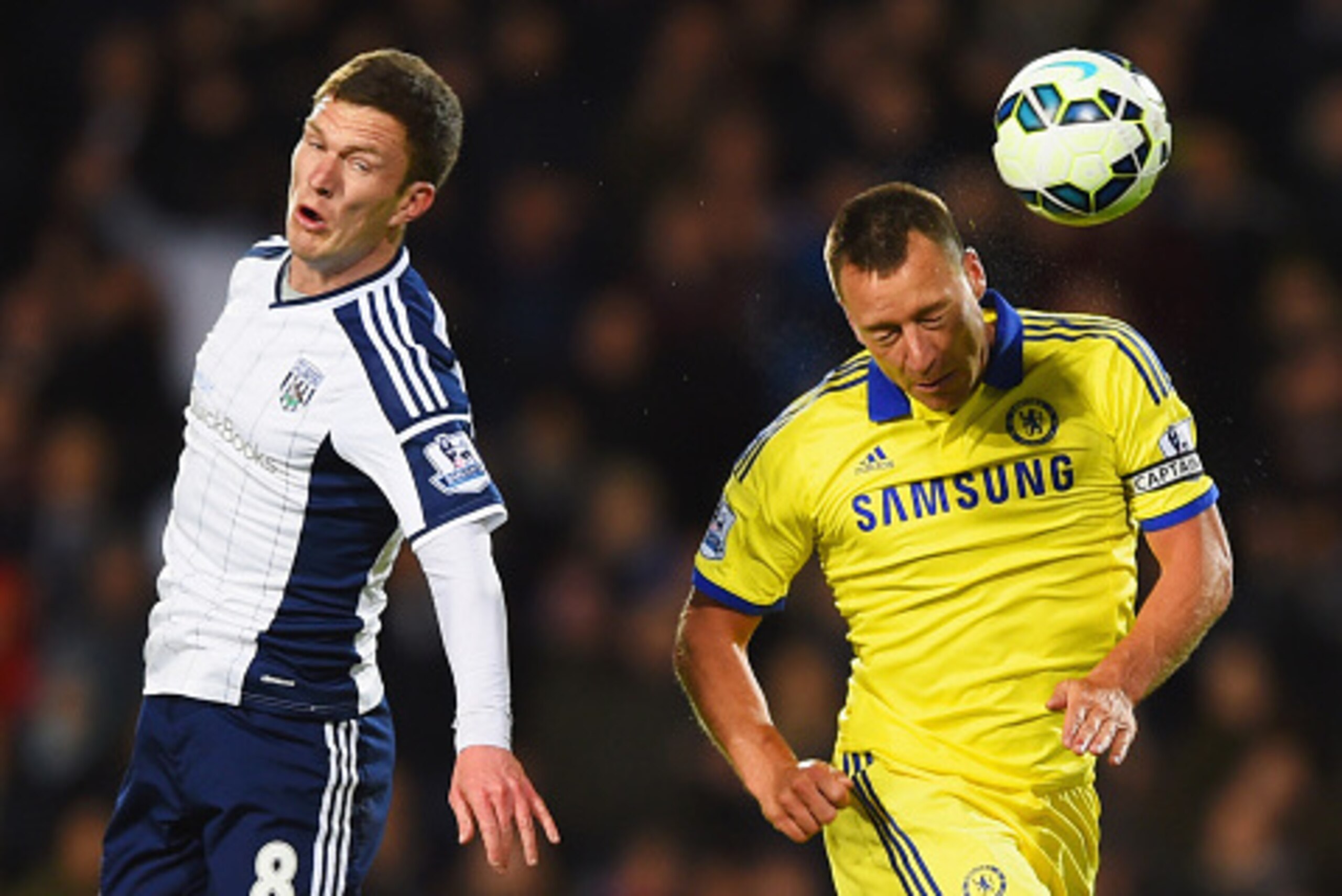 WEST BROMWICH, ENGLAND - MAY 18:  John Terry of Chelsea and Craig Gardner of West Bromwich Albion jump for the ball during the Barclays Premier League match between West Bromwich Albion and Chelsea at The Hawthorns on May 18, 2015 in West Bromwich, Englan