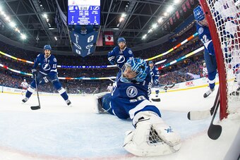 TAMPA, FL - MAY 22: Goalie Ben Bishop #30 of the Tampa Bay Lightning reaches back for the puck after a shot by Rick Nash #61 of the New York Rangers during the third period in Game Four of the Eastern Conference Final during the 2015 NHL Stanley Cup Playo