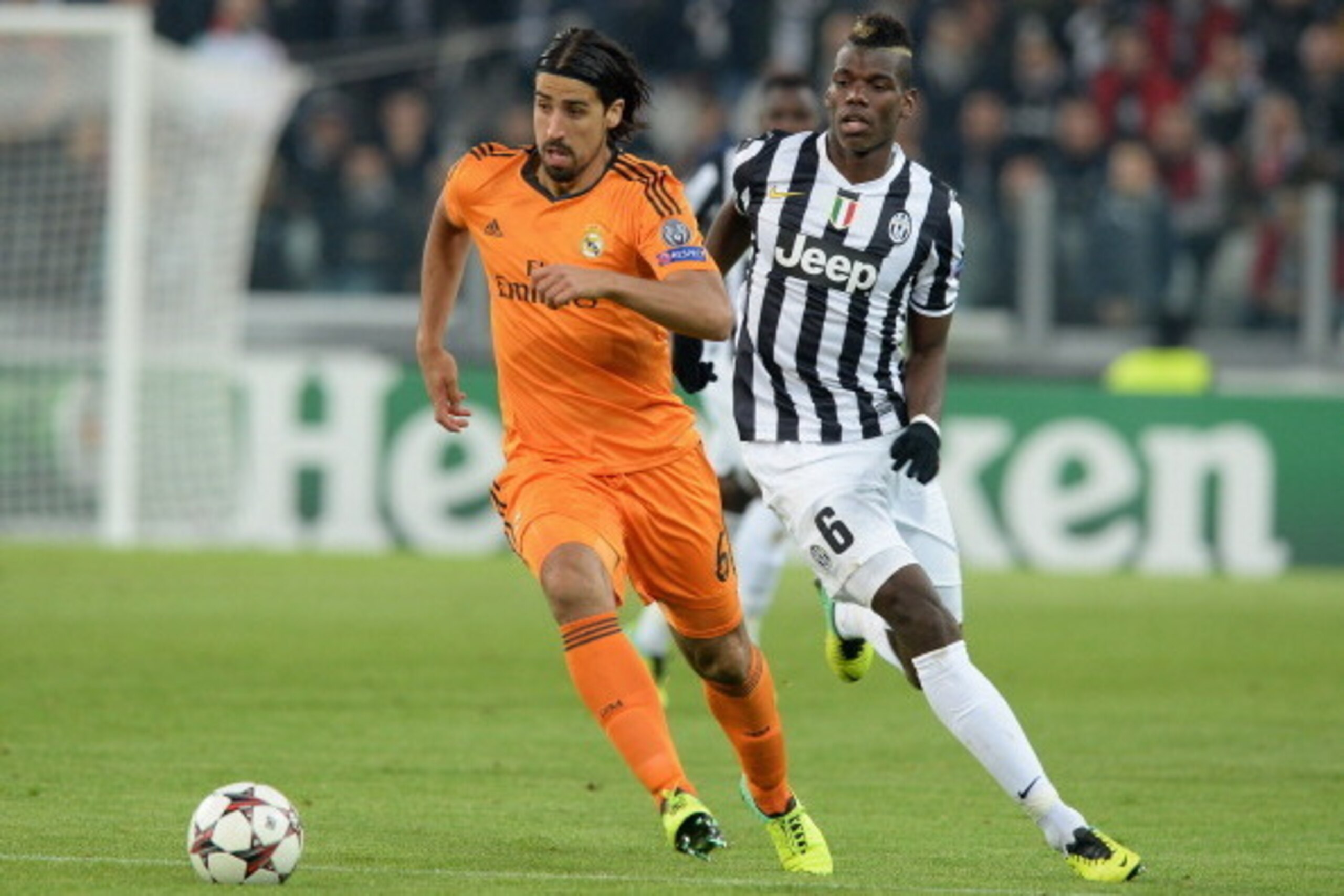 TURIN, ITALY - NOVEMBER 05:  Paul Pogba of Juventus and Sami Khedira of Real Madrid (L) compete for the ball during the UEFA Champions League Group B match between Juventus and Real Madrid at Juventus Arena on November 5, 2013 in Turin, Italy.  (Photo by 