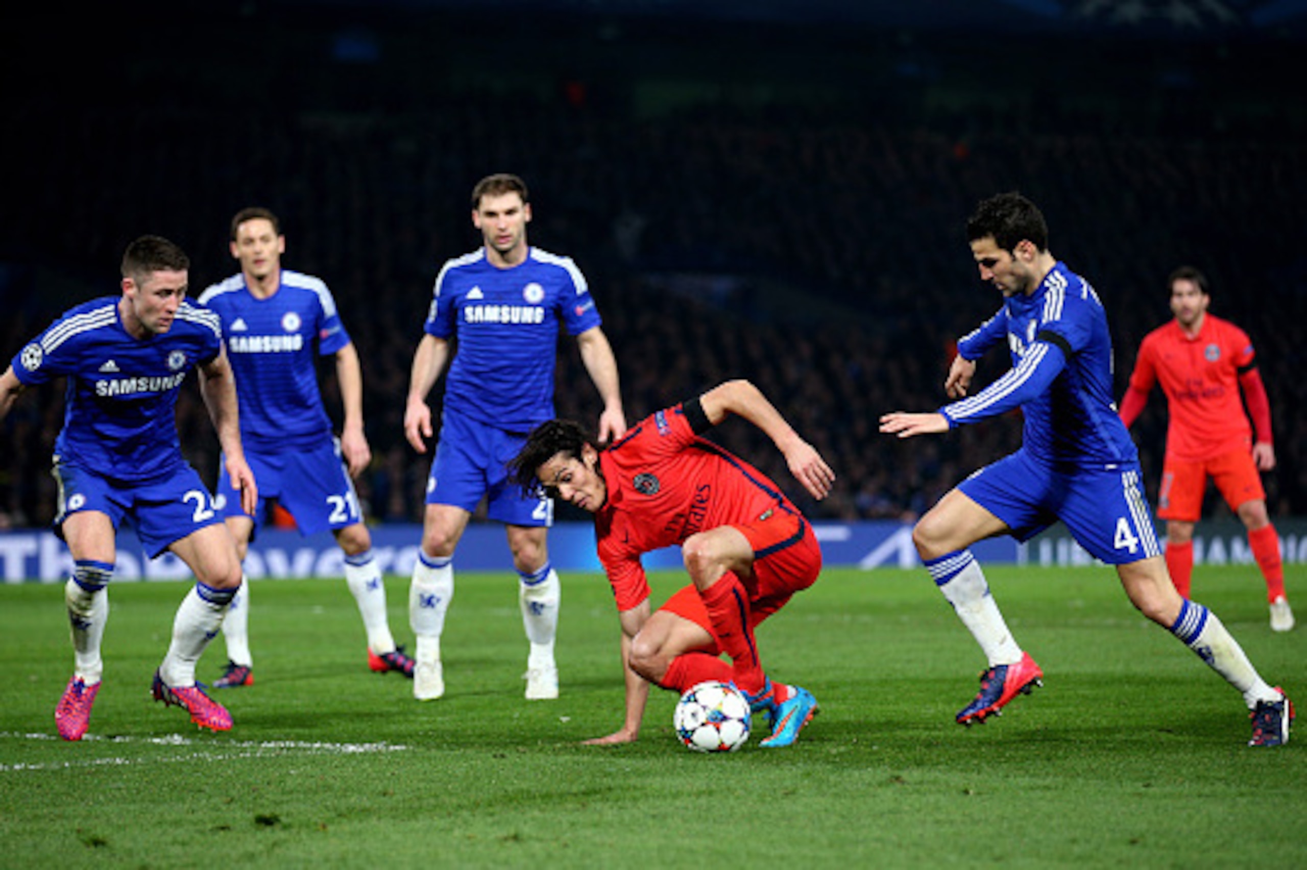 LONDON, ENGLAND - MARCH 11:  Edinson Cavani of PSG is closed own by Cesc Fabregas (R) of Chelsea and his teammates during the UEFA Champions League Round of 16, second leg match between Chelsea and Paris Saint-Germain at Stamford Bridge on March 11, 2015 