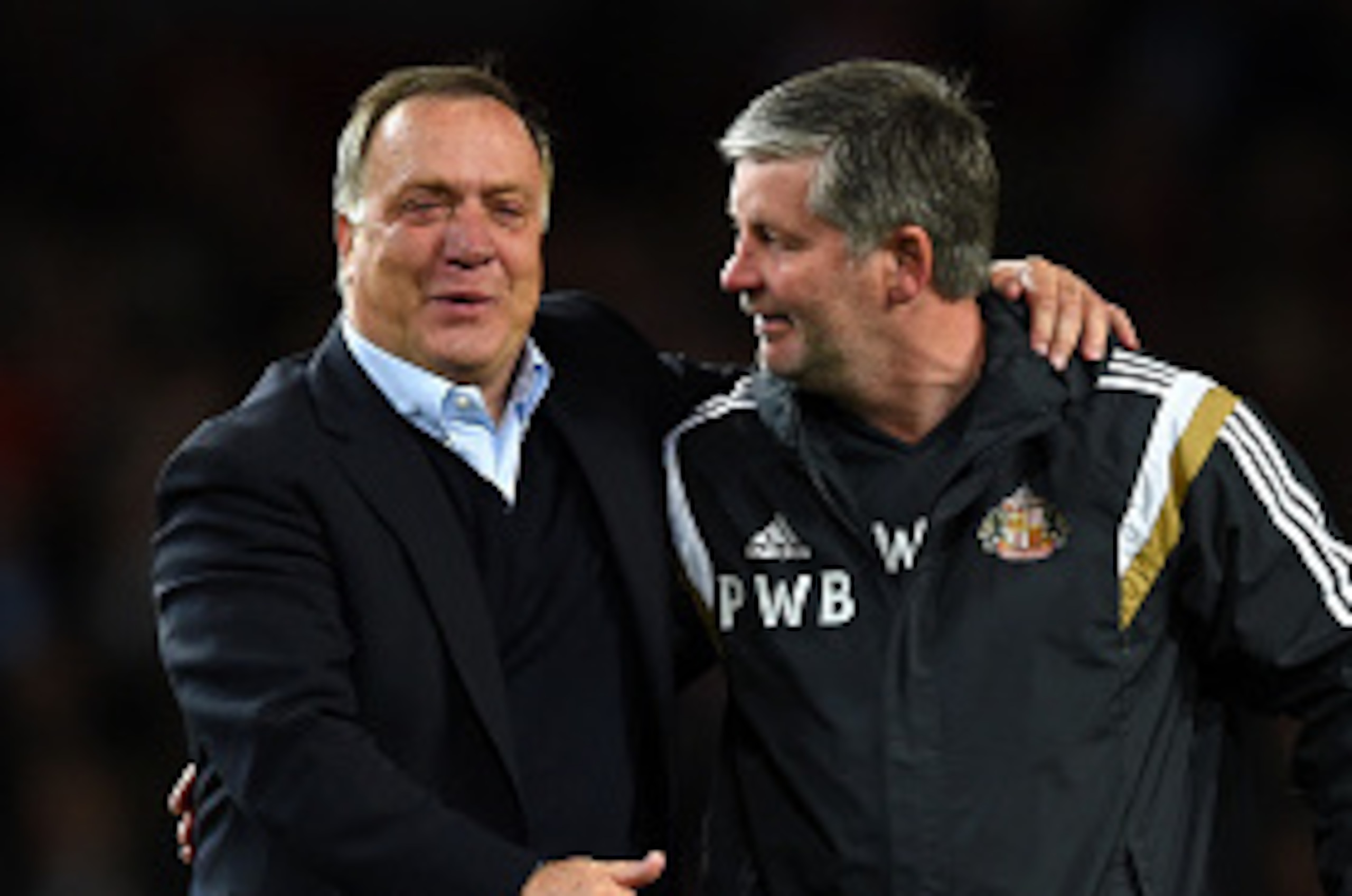 LONDON, ENGLAND - MAY 20:  Dick Advocaat, Manager of Sunderland (L) celebrates with a member of coaching staff as his team avoid relegation during the Barclays Premier League match between Arsenal and Sunderland at Emirates Stadium on May 20, 2015 in Lond
