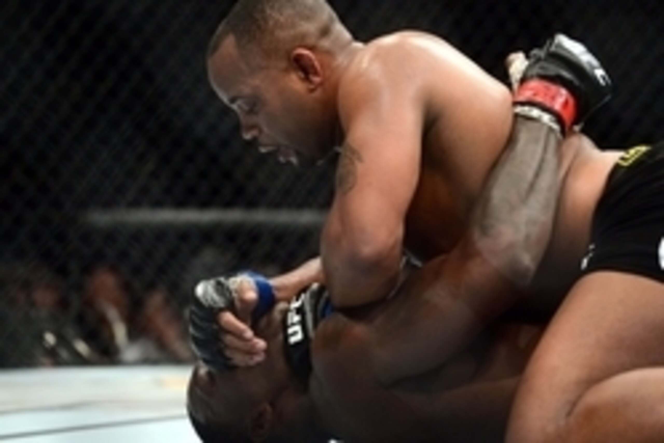 May 23, 2015; Las Vegas, NV, USA; Anthony Johnson (red gloves) and Daniel Cormier (blue gloves) fight during their light heavyweight championship bout during UFC 187 at MGM Grand Garden Arena. Cormier won via third round TKO. Mandatory Credit: Joe Campore