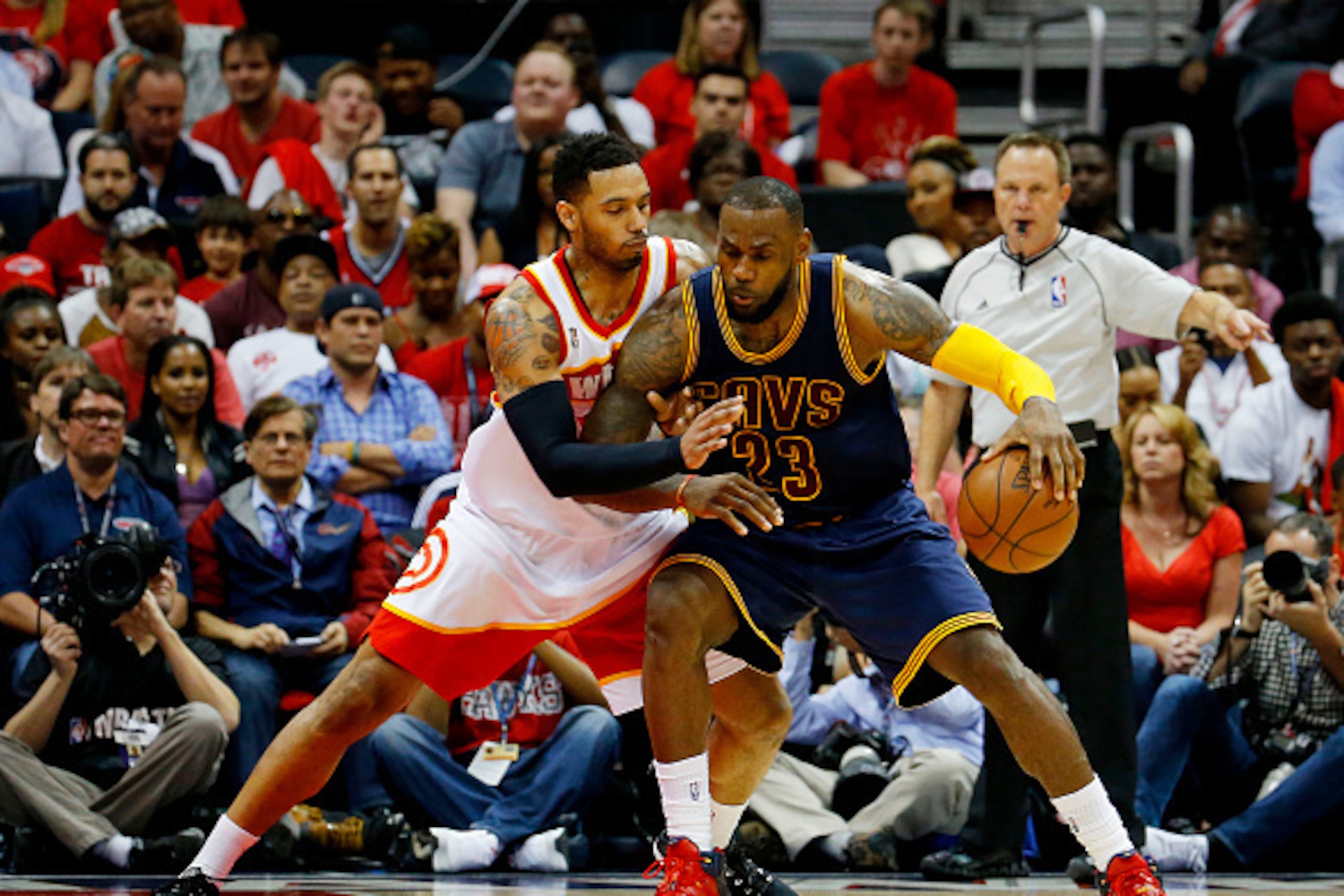 ATLANTA, GA - MAY 22:  LeBron James #23 of the Cleveland Cavaliers drives against Mike Scott #32 of the Atlanta Hawks in the fourth quarter during Game Two of the Eastern Conference Finals of the 2015 NBA Playoffs at Philips Arena on May 22, 2015 in Atlan