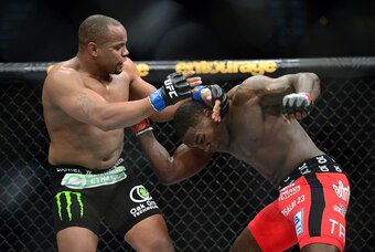 May 23, 2015; Las Vegas, NV, USA; Anthony Johnson (red gloves) and Daniel Cormier (blue gloves) fight during their light heavyweight championship bout during UFC 187 at MGM Grand Garden Arena. Cormier won via third round TKO. Mandatory Credit: Joe Campore