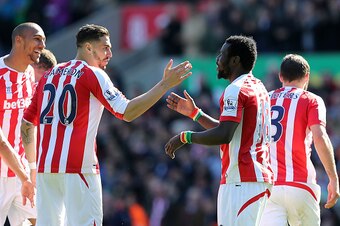 STOKE ON TRENT, ENGLAND - APRIL 18:  Mame Diouf of Stoke celebrates scoring his team's first goal with team-mate Geoff Cameron (L) during the Barclays Premier League match between Stoke City and Southampton at the Britannia Stadium on April 18, 2015 in St