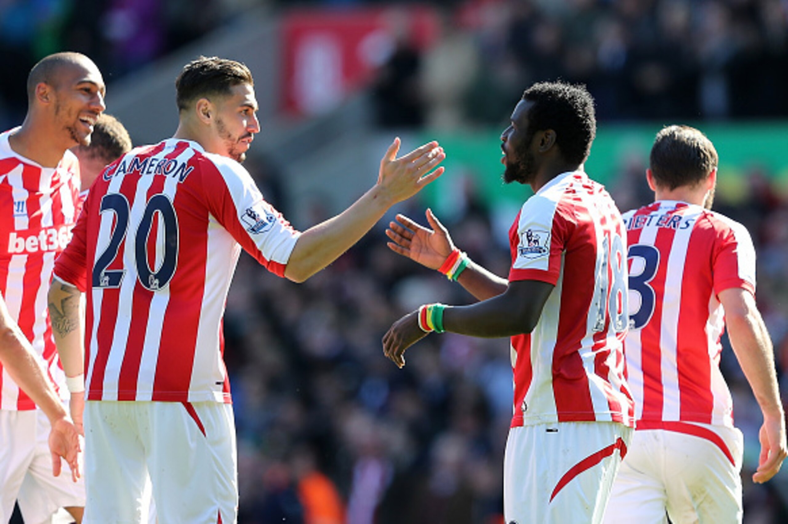 STOKE ON TRENT, ENGLAND - APRIL 18:  Mame Diouf of Stoke celebrates scoring his team's first goal with team-mate Geoff Cameron (L) during the Barclays Premier League match between Stoke City and Southampton at the Britannia Stadium on April 18, 2015 in St