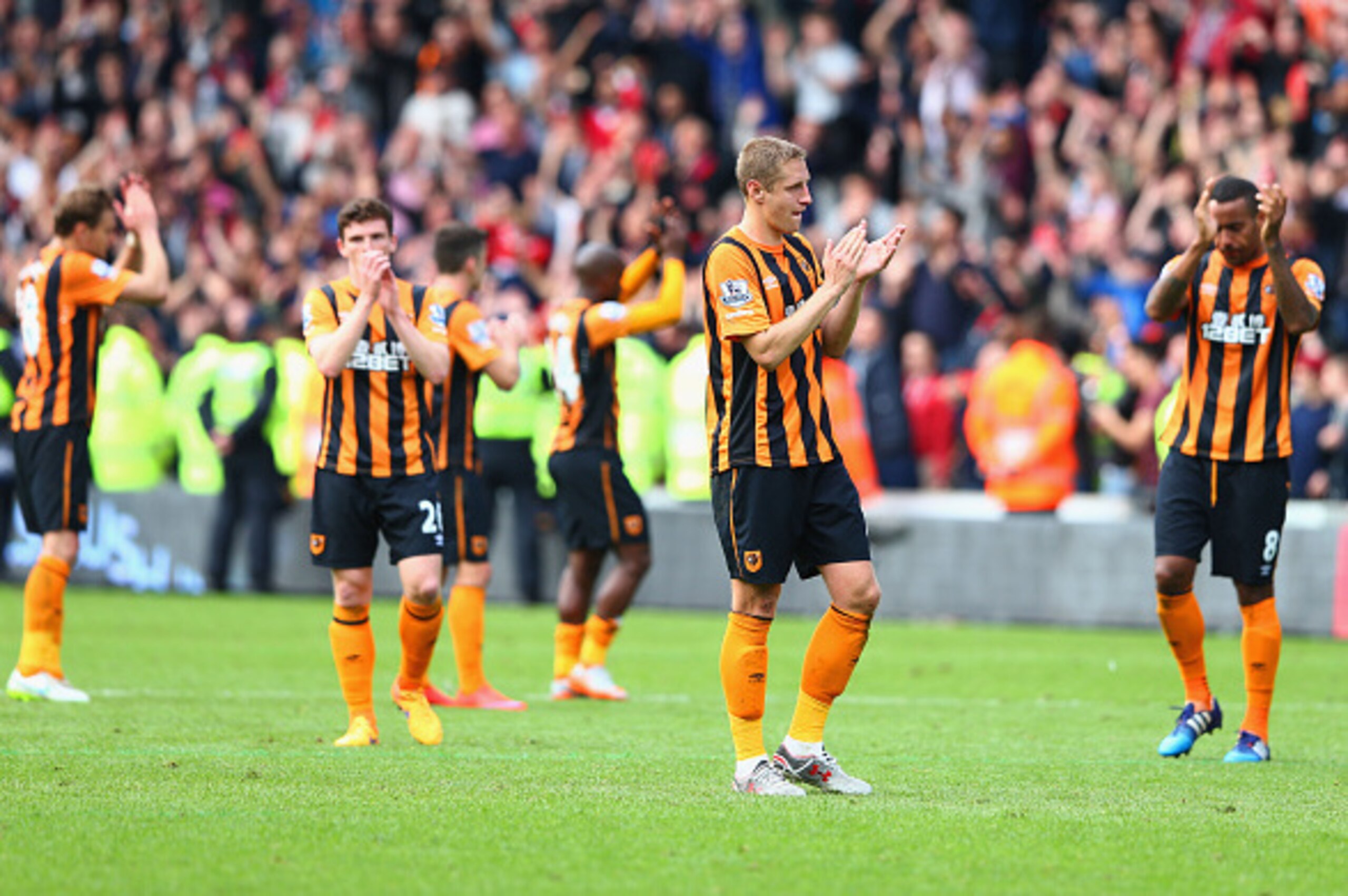 HULL, ENGLAND - MAY 24:  Michael Dawson (2nd R) and Hull City players applaud supporters after relegated from the Premier League during the Barclays Premier League match between Hull City and Manchester United at KC Stadium on May 24, 2015 in Hull, Englan