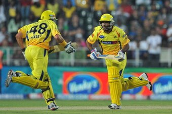 JOHANNESBURG, SOUTH AFRICA - SEPTEMBER 26: Mike Hussey and Mahendra Singh Dhoni  of the Kings on the run during the 2010 Airtel Champions League Twenty20 final match between Chennai Super Kings and Chevrolet Warriors from Bidvest Wanderers Stadium on Sept