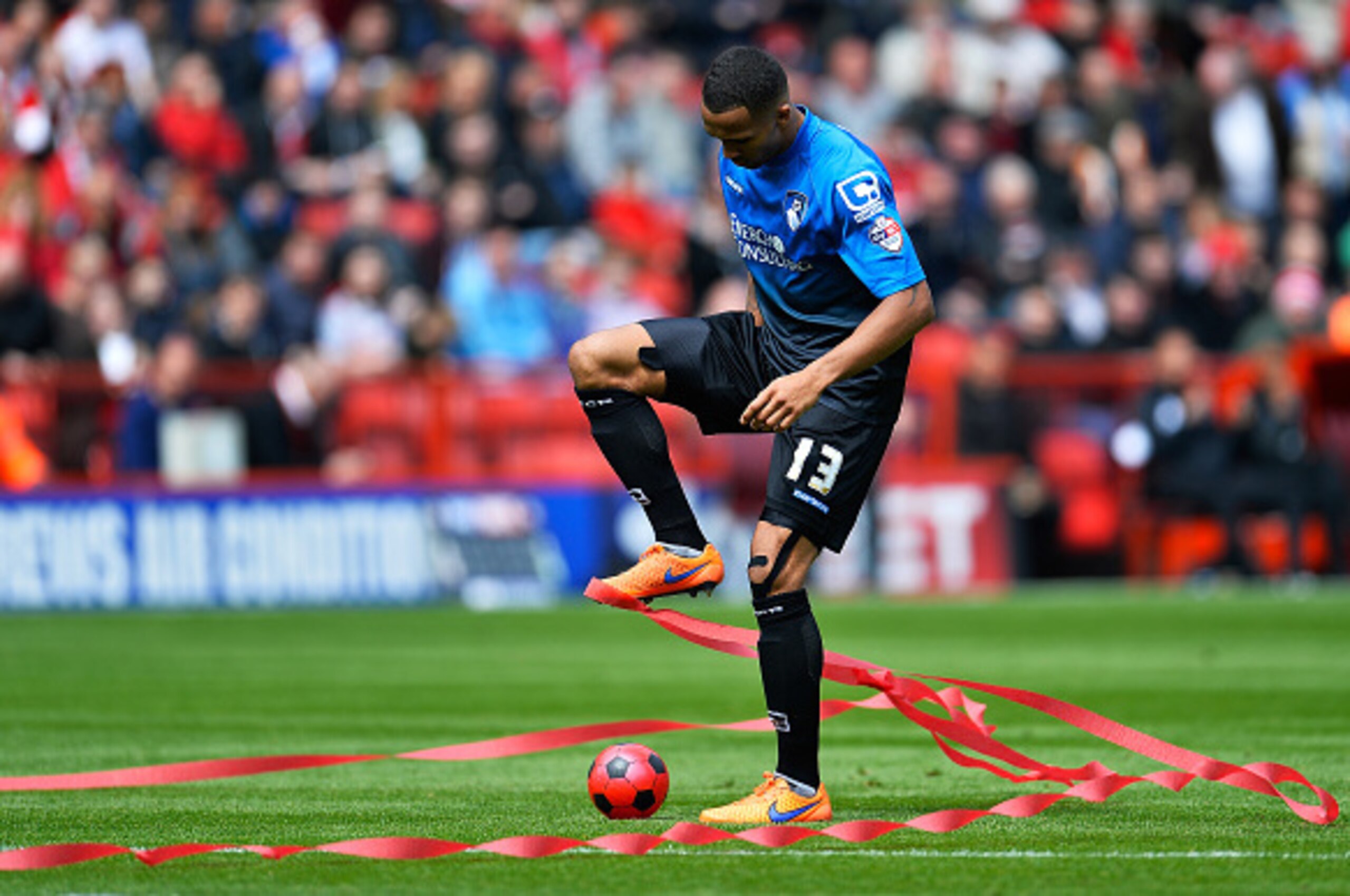 LONDON, ENGLAND - MAY 02:  Callum Wilson of AFC Bournemouth gets cauht up in streamers during the Sky Bet Championship match between Charlton Athletic and AFC Bournemouth at The Valley on May 2, 2015 in London, England.  (Photo by Justin Setterfield/Getty