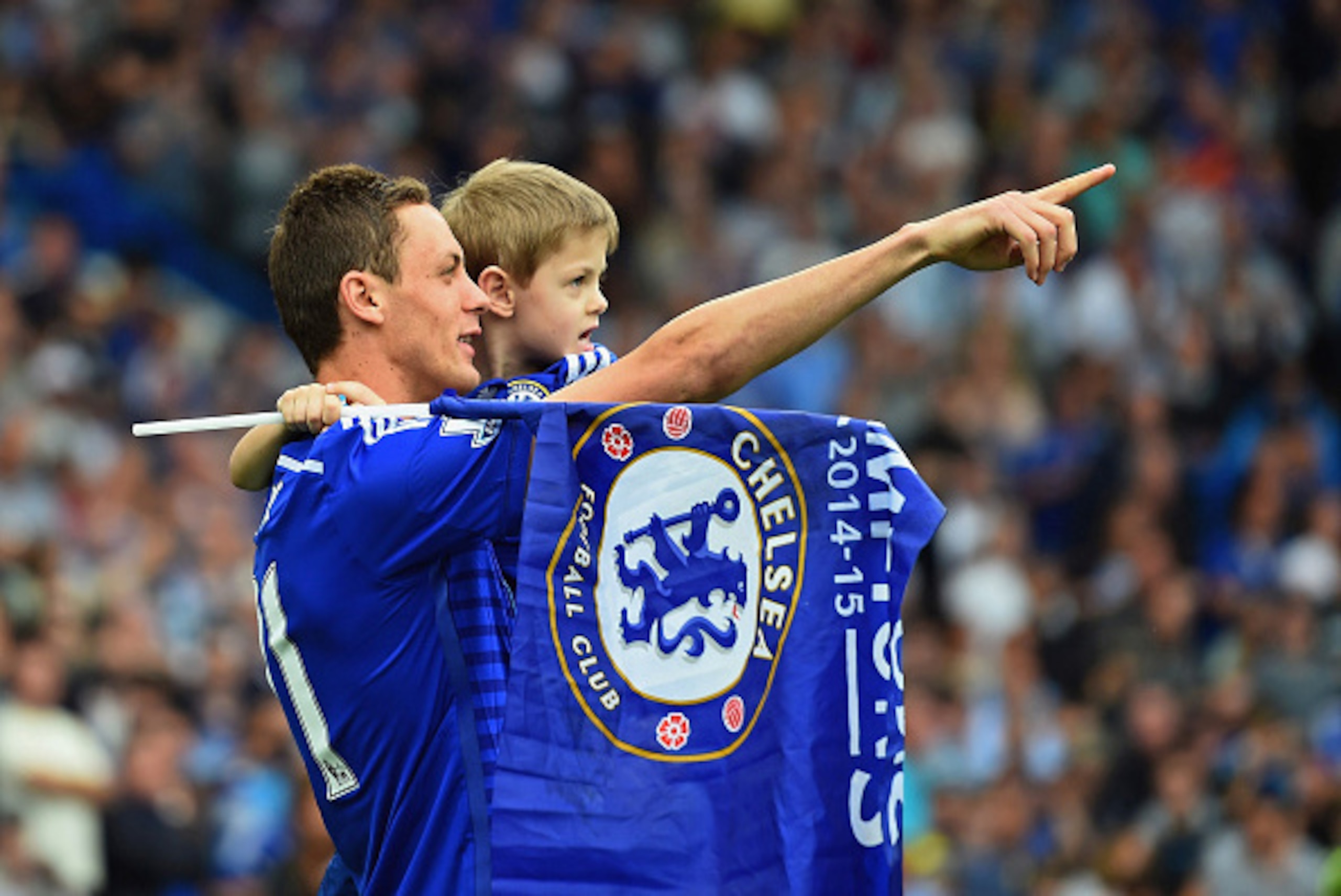 LONDON, ENGLAND - MAY 24:  Nemanja Matic of Chelsea celebrates winning the Premier League title with his child after the Barclays Premier League match between Chelsea and Sunderland at Stamford Bridge on May 24, 2015 in London, England.  (Photo by Laurenc
